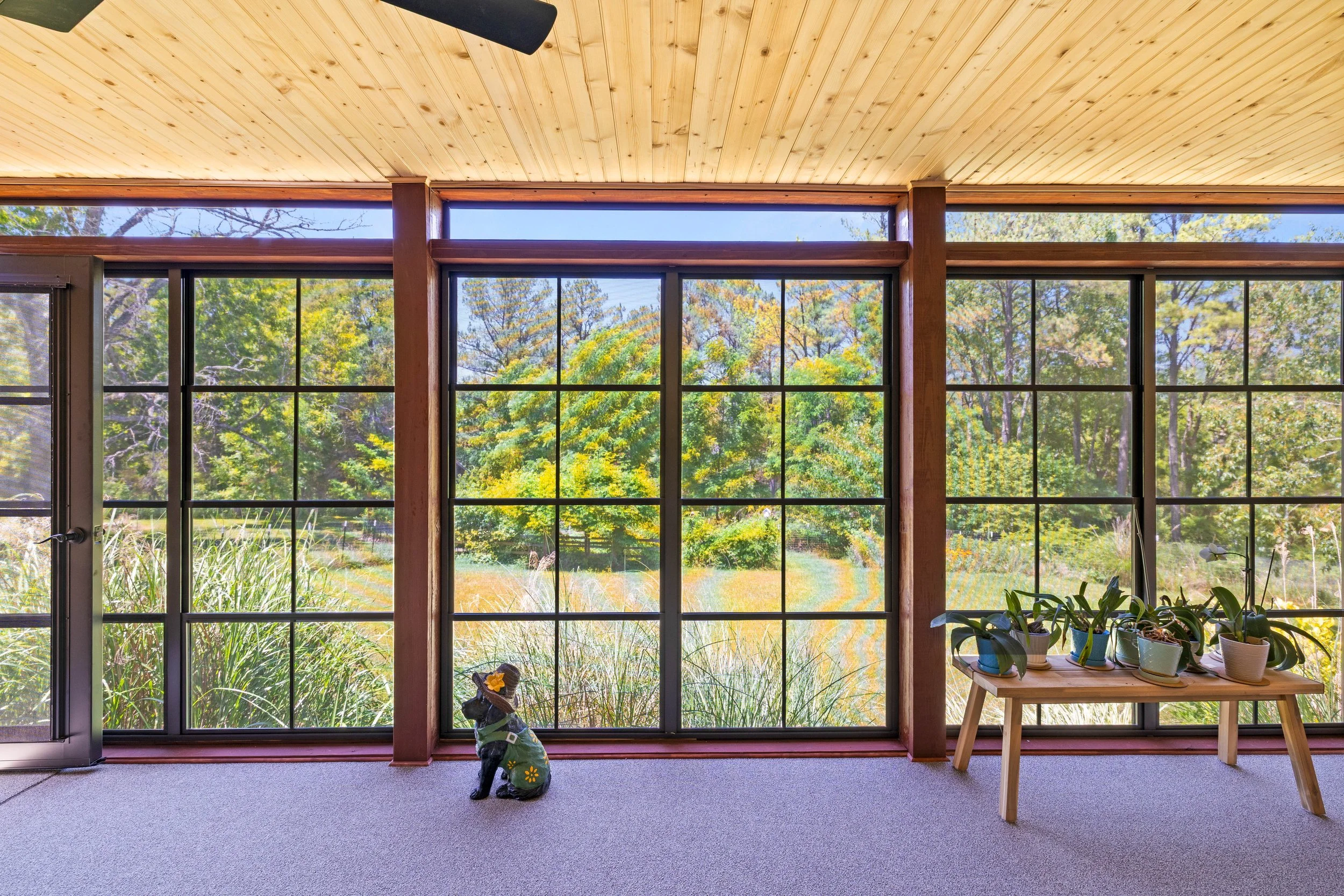 Exterior view of a completed three-season room overlooking a backyard garden in Blacksburg, Virginia.