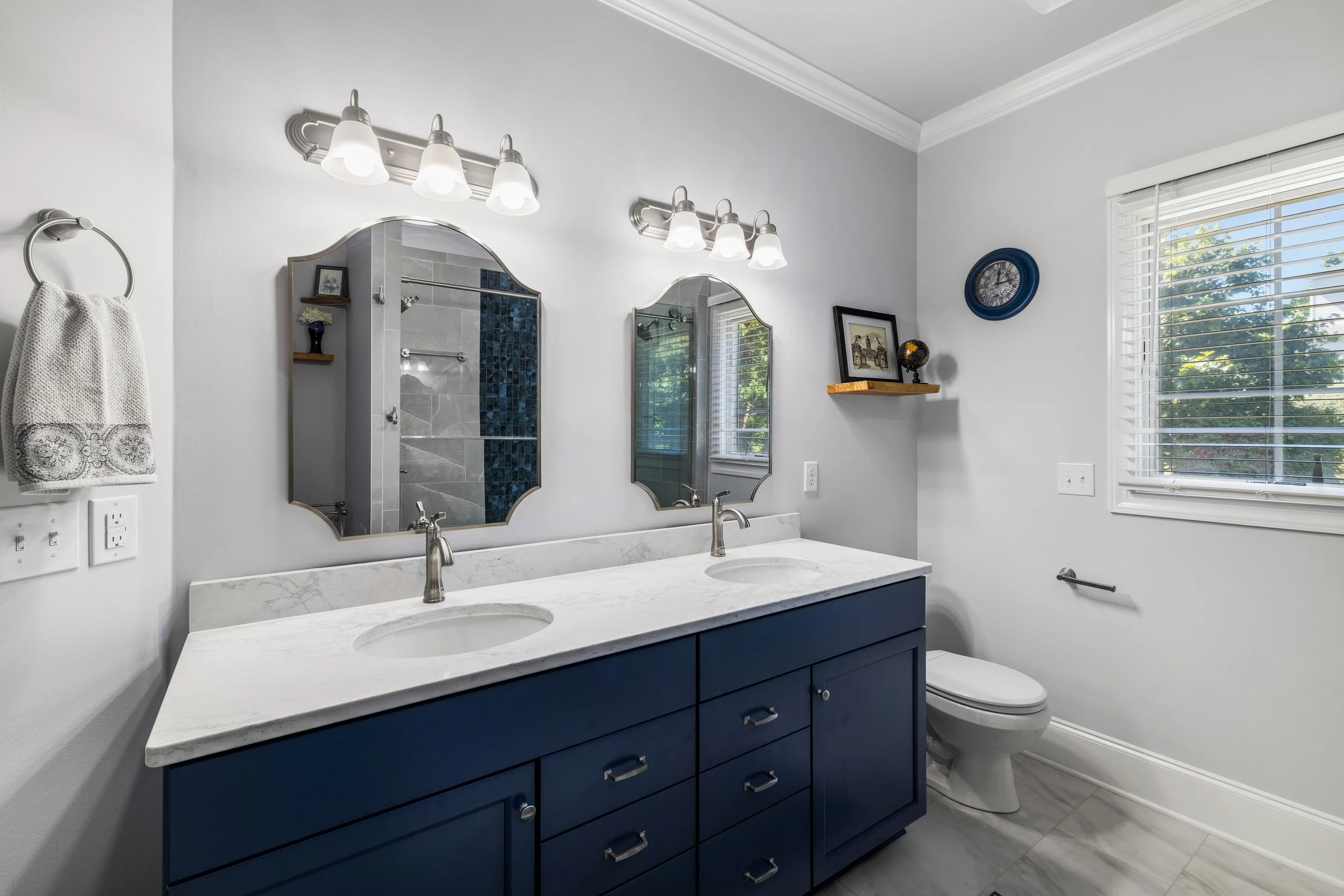 Blue double-sink vanity in the remodeled Wyatt Farms primary bathroom.