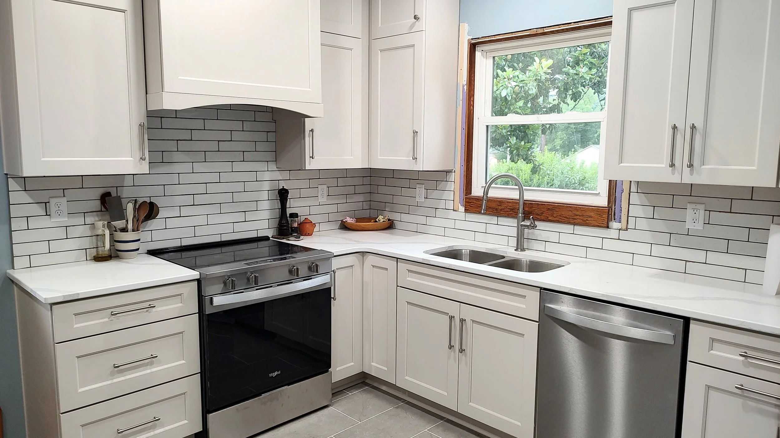In-progress kitchen renovation in a 1919 Sears kit house in Pembroke, Virginia, with new cabinets, flooring and countertops installed.