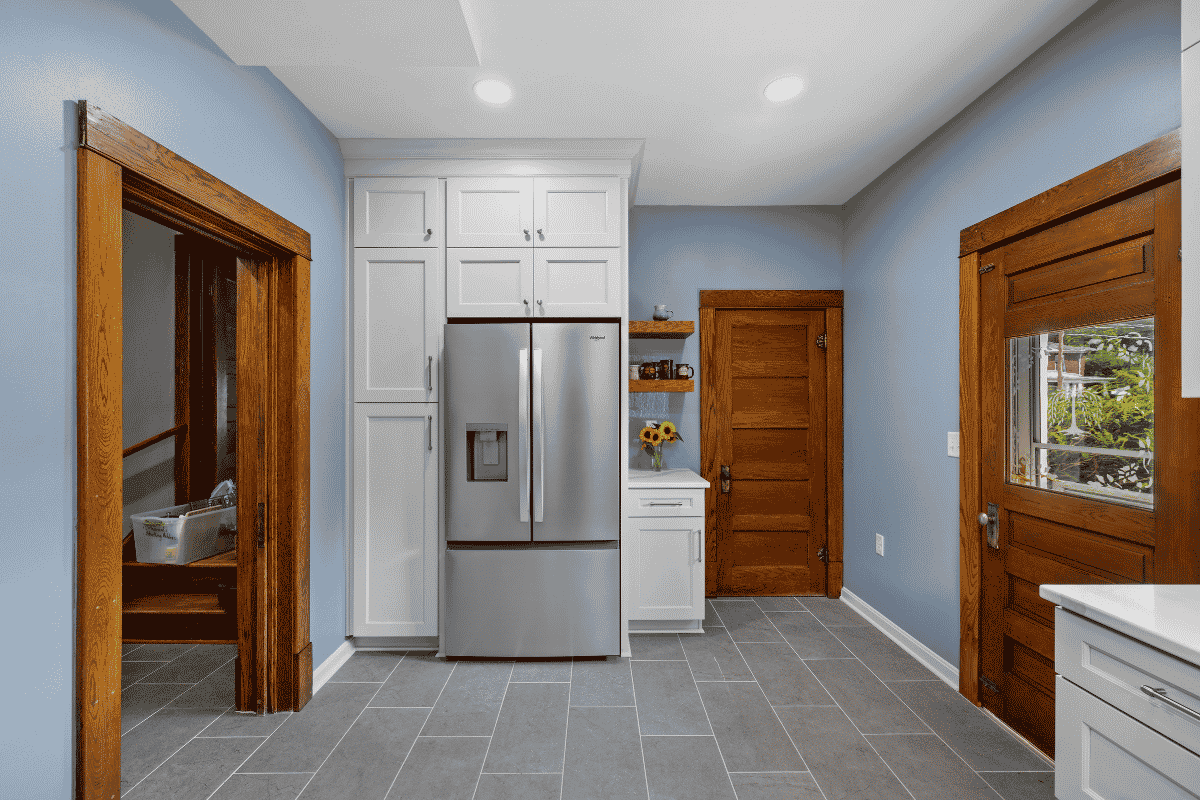 Original stained wood trim preserved in the renovated kitchen of a 1919 Sears kit house in Pembroke, Virginia.