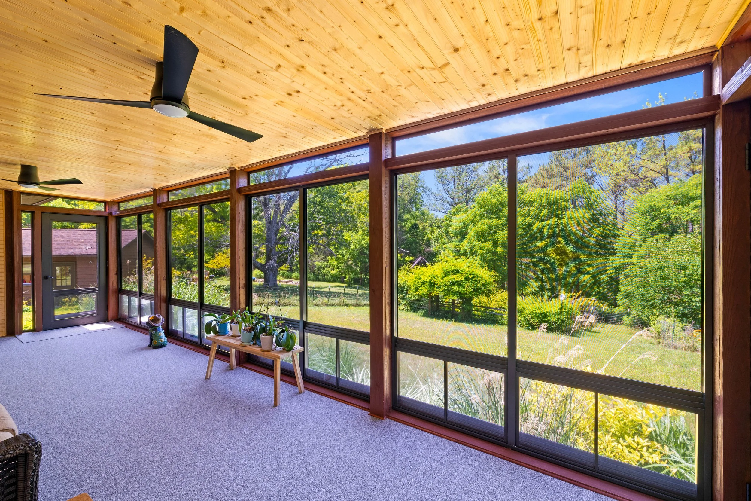 SunSpace window panels opened to screens inside a three-season room in Blacksburg, Virginia.