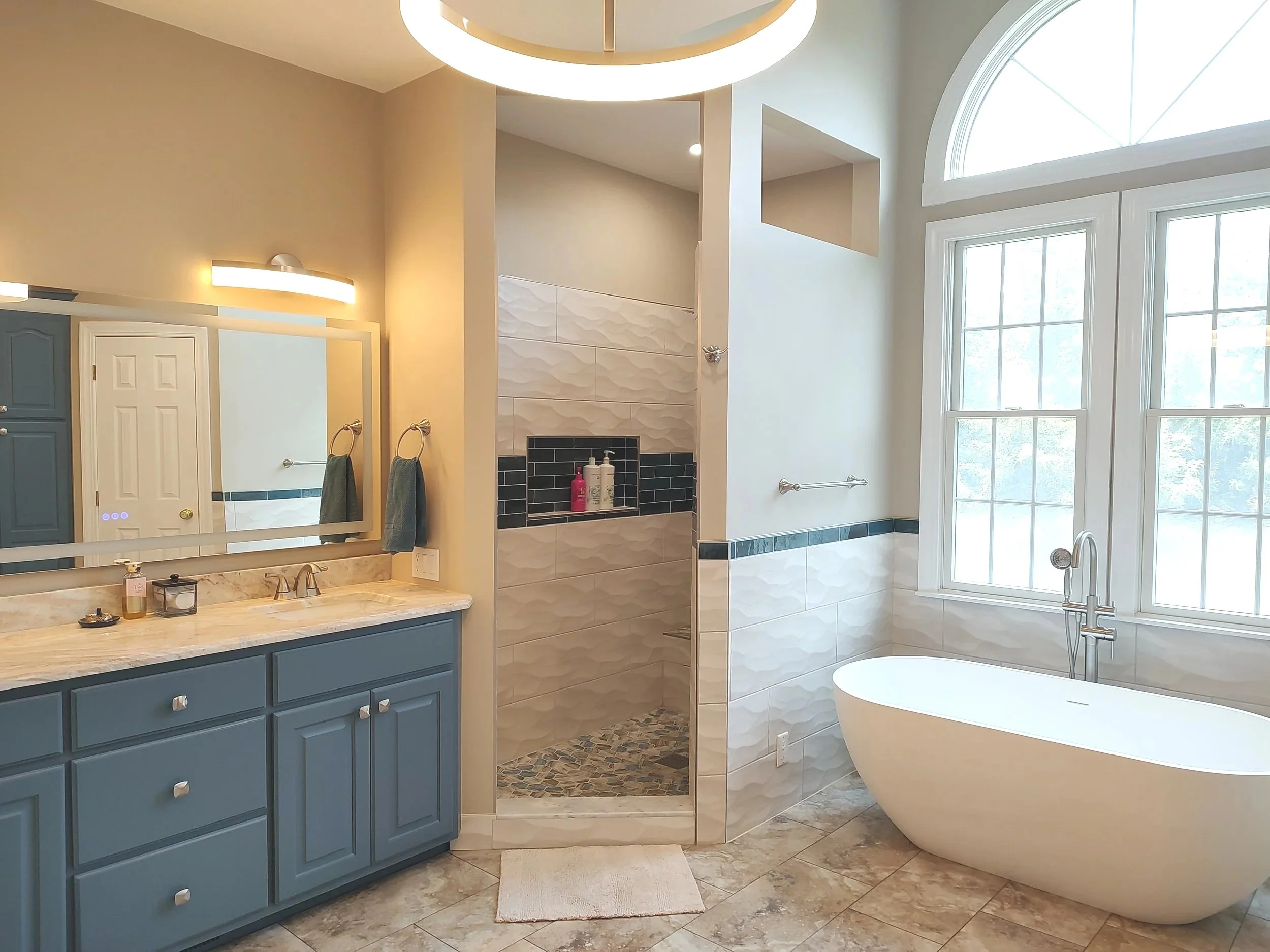 Remodeled primary bathroom in Riner, Virginia with custom tile, updated fixtures and a refreshed layout