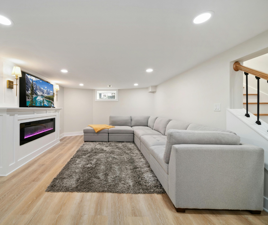 Finished basement family room with sectional sofa and wall-mounted TV