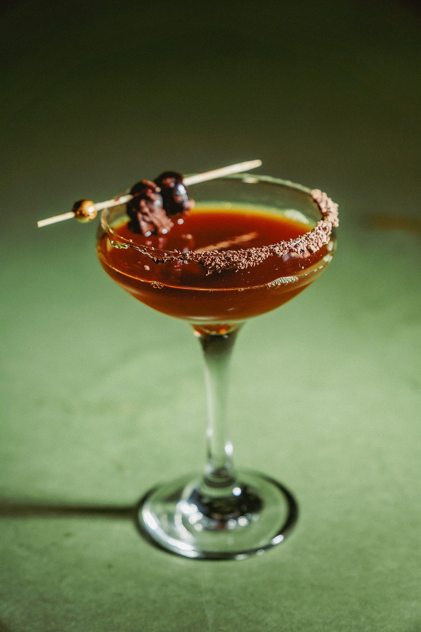 Espresso martini at The Rossi Kitchen + Bar in Columbus, Ohio, finished with espresso beans and a cocoa-rimmed coupe.