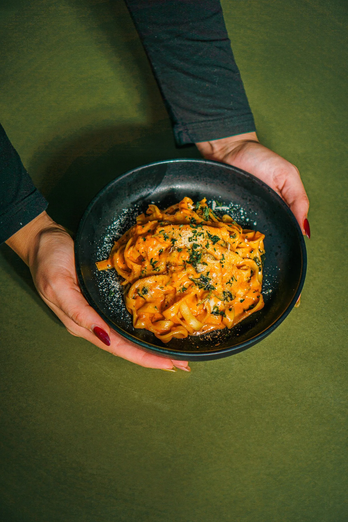 Fresh handmade pasta at The Rossi Kitchen + Bar in Columbus, Ohio, featuring creamy Italian noodles topped with herbs and grated cheese.