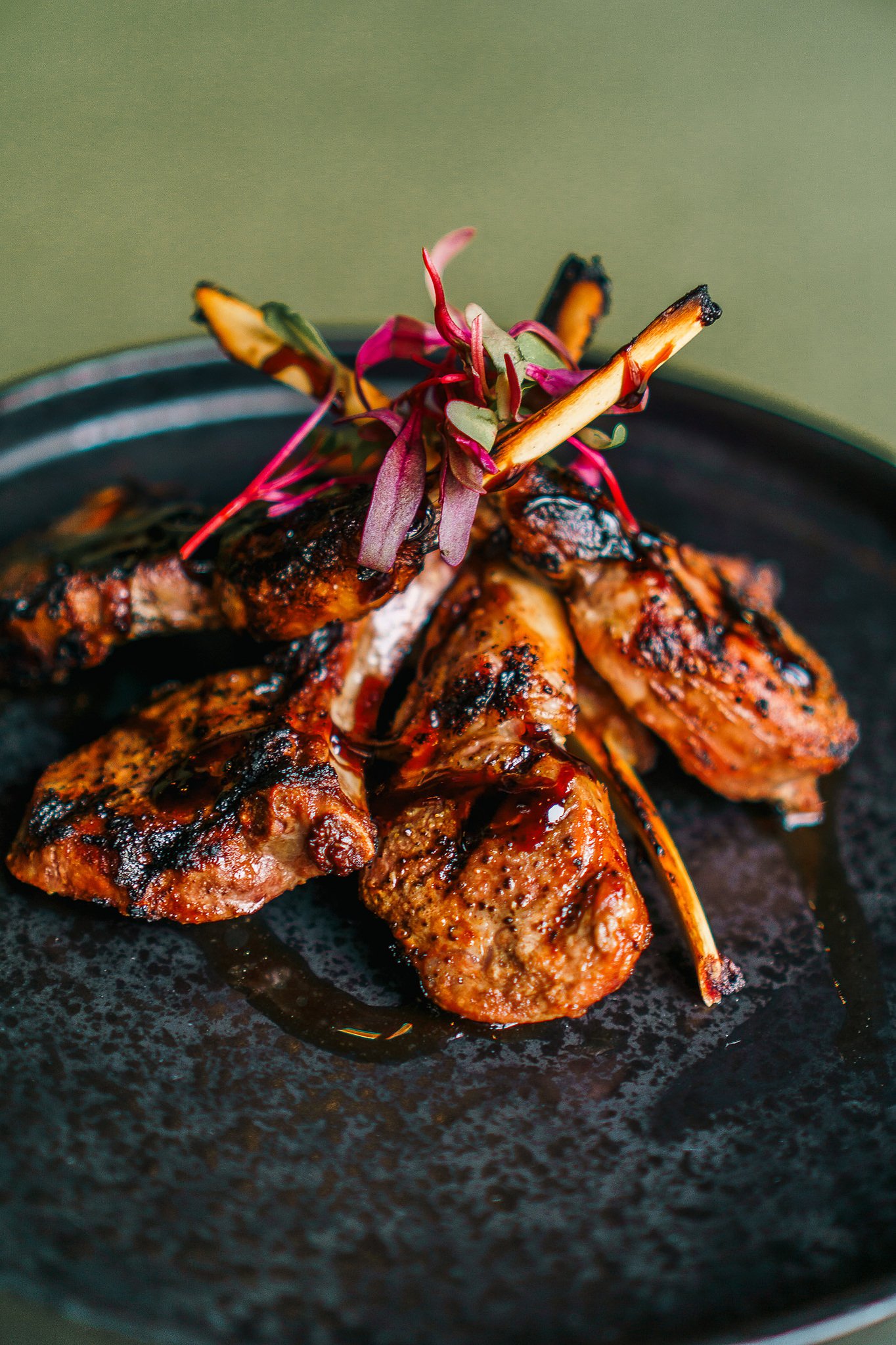 Grilled lamb chops at The Rossi Kitchen + Bar in Columbus, Ohio, served with seasonal garnish and Italian-inspired preparation.