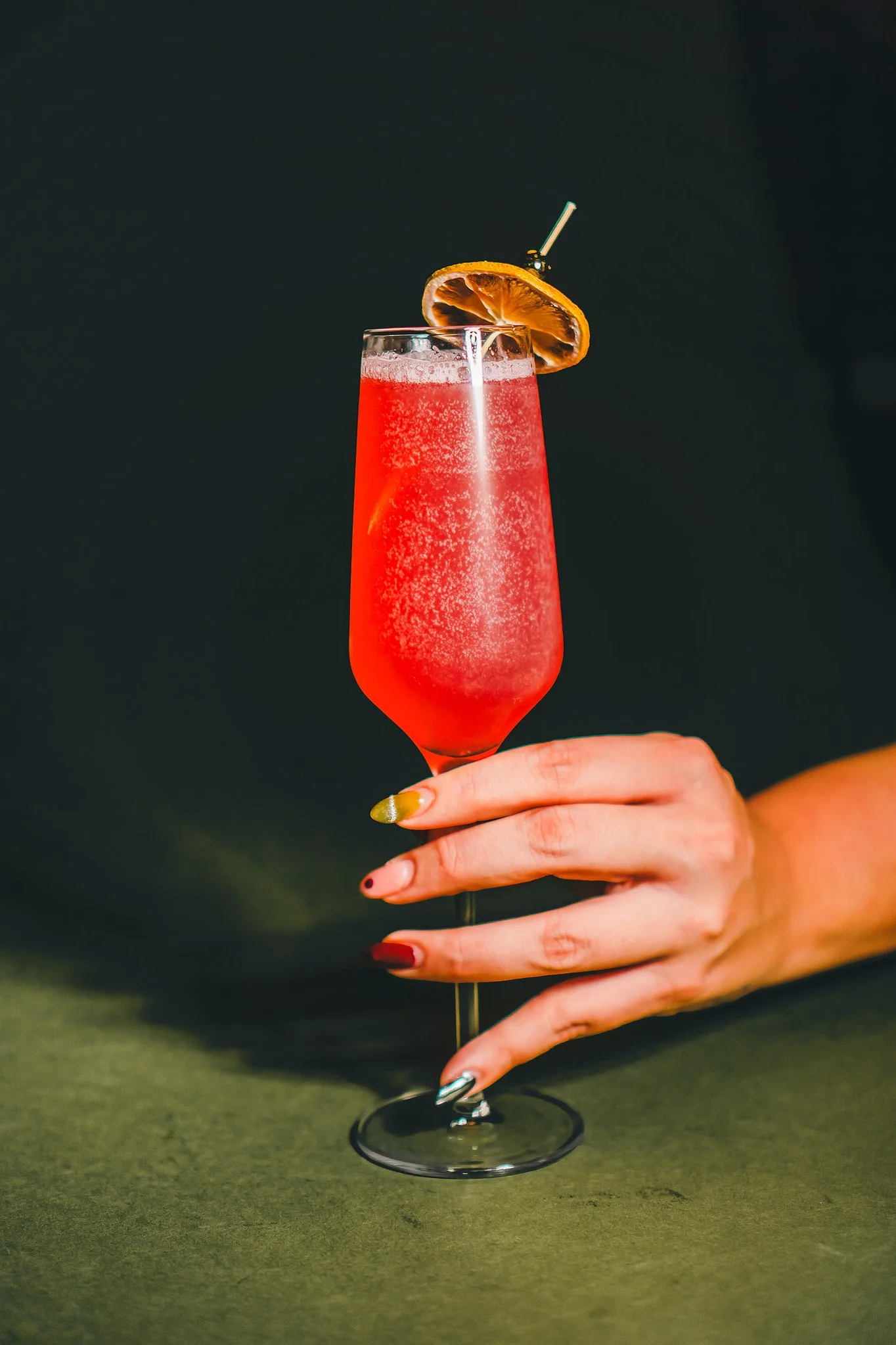 Handcrafted Italian cocktail at The Rossi Kitchen + Bar in Columbus, Ohio, featuring a vibrant sparkling drink garnished with a dried citrus wheel.