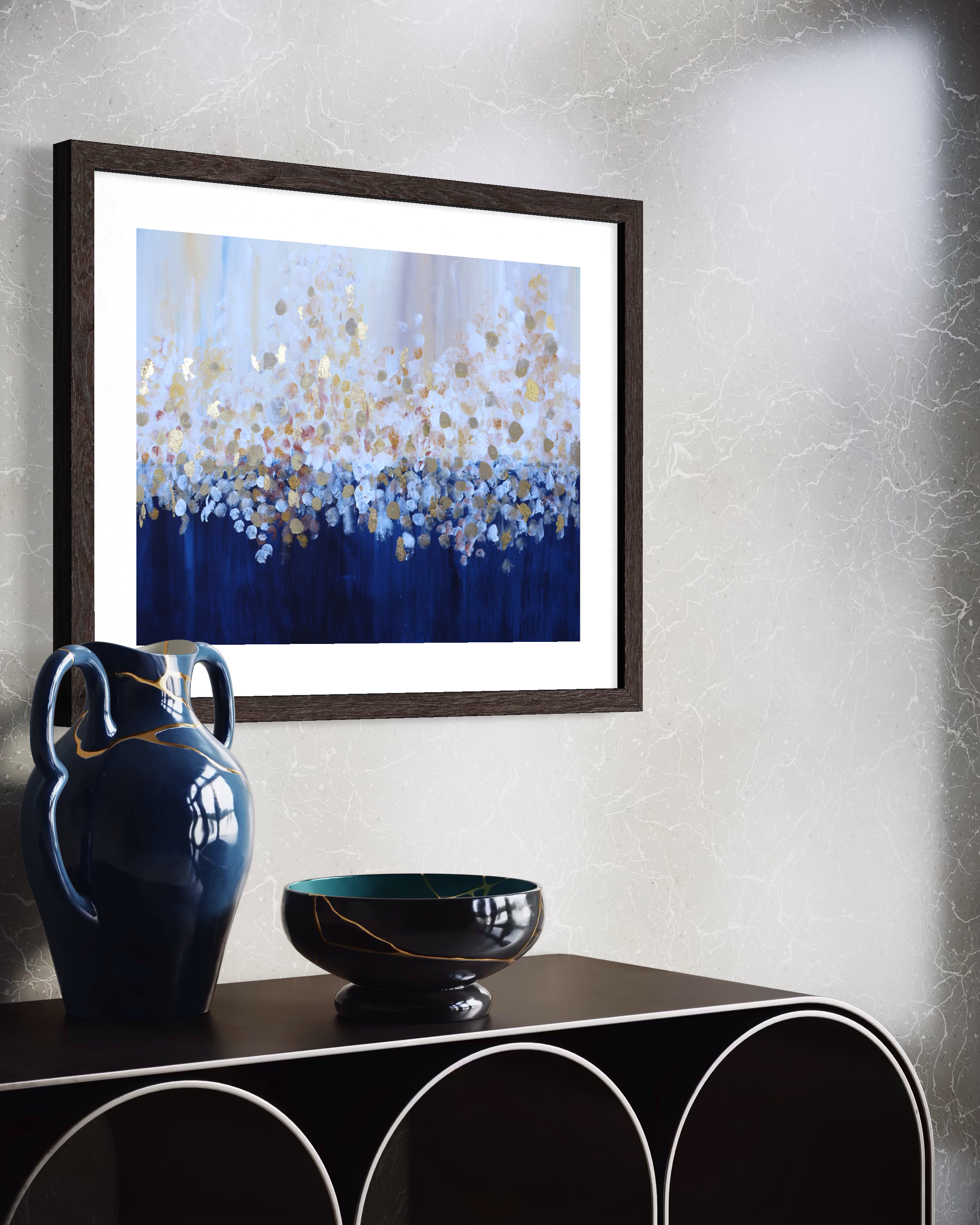 Morning abstract blue and gold art print by Louise Duggan displayed framed above blue ceramics.