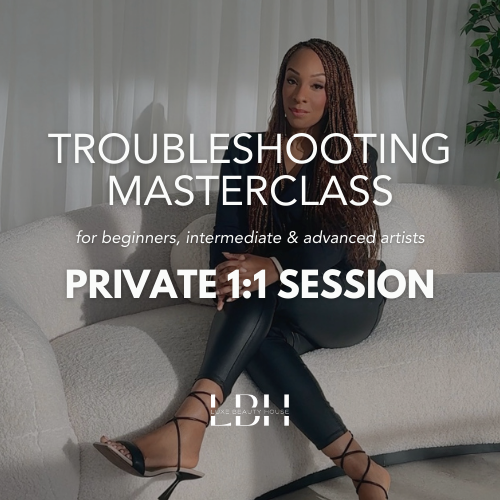 Woman sitting on a white couch holding a phone, promoting a troubleshooting masterclass for artists.