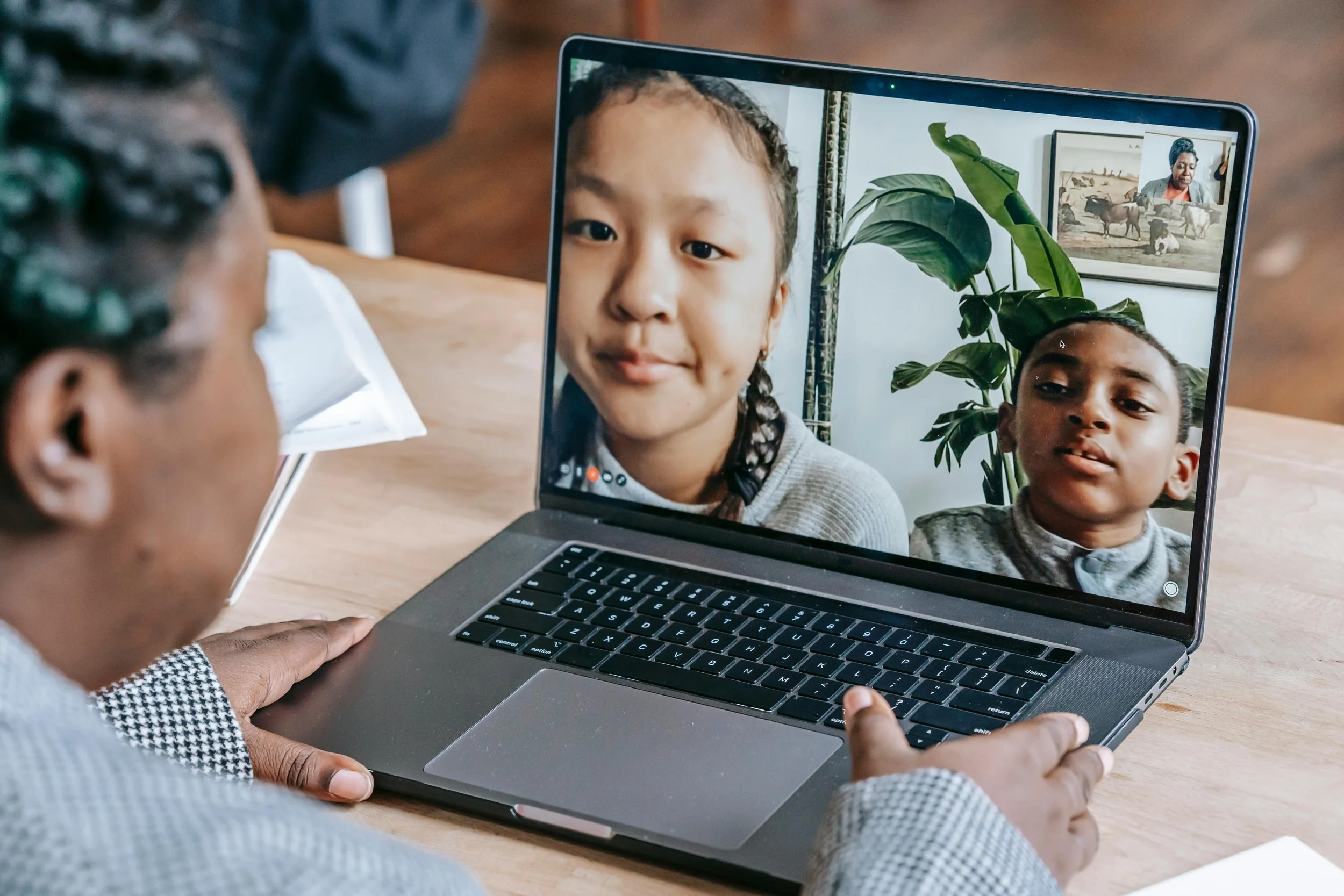 A virtual school teacher talks to two students
