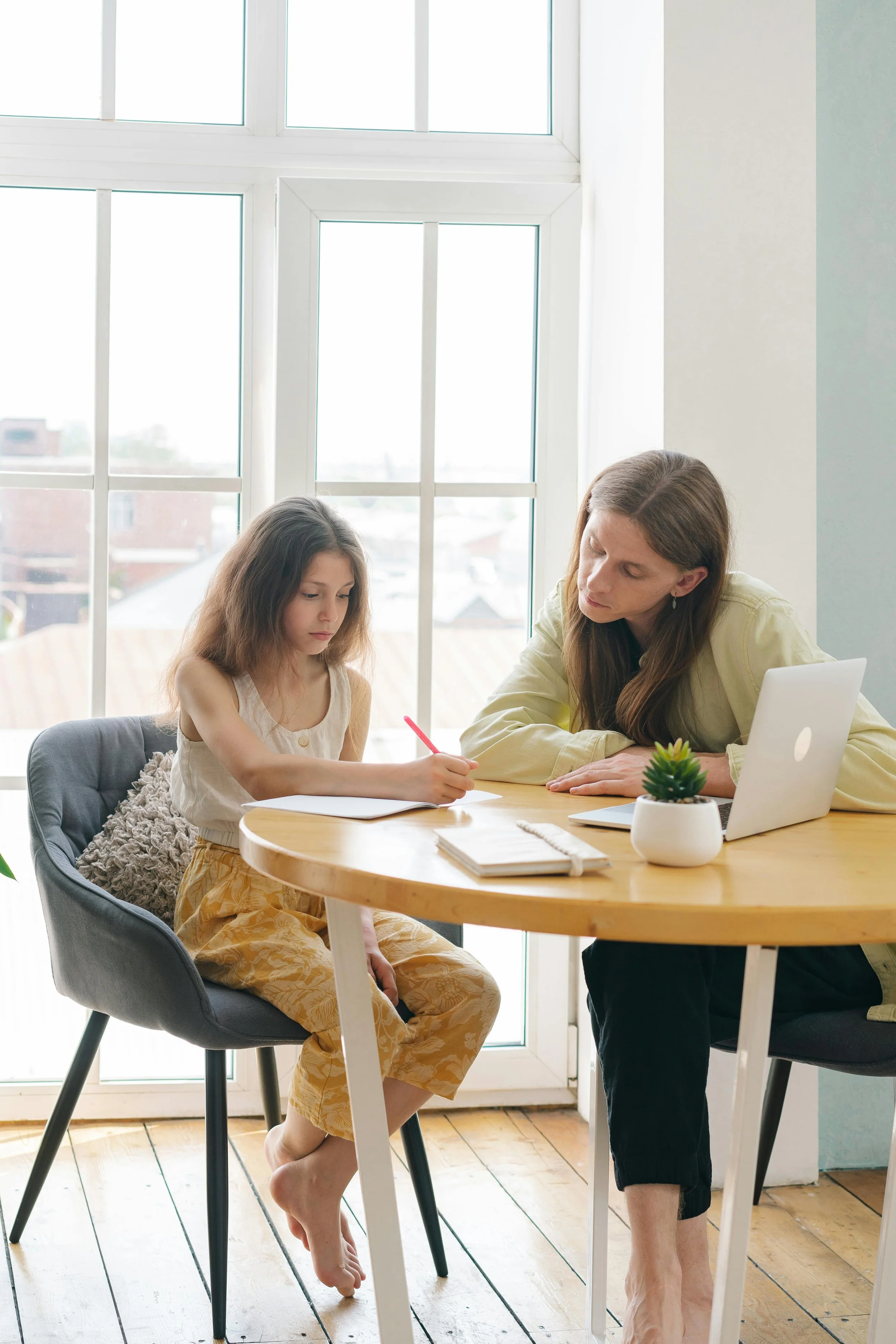 A parent helps their child with homework