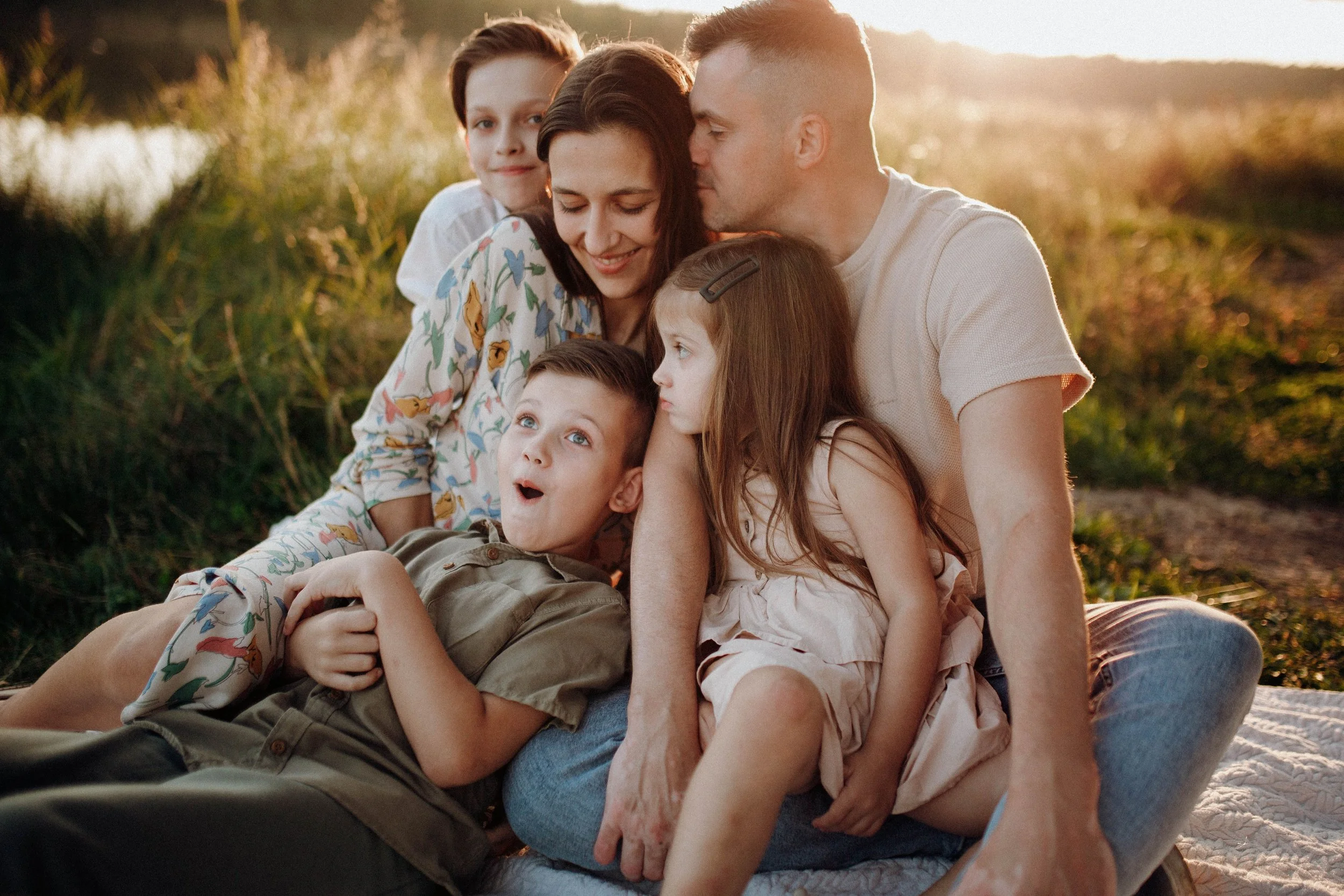 A family sits outside in the sun