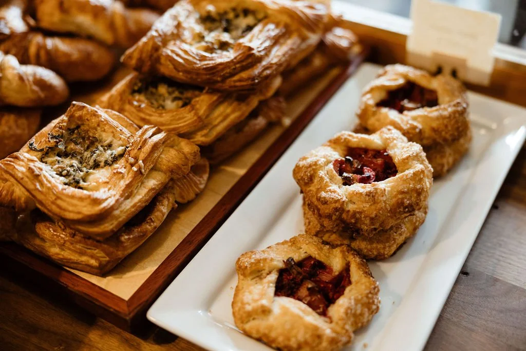 Assorted pastries on wooden tray and white plate