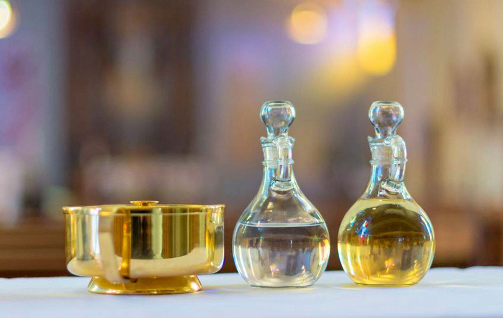 Communion vessels with glass decanters and golden bowl.