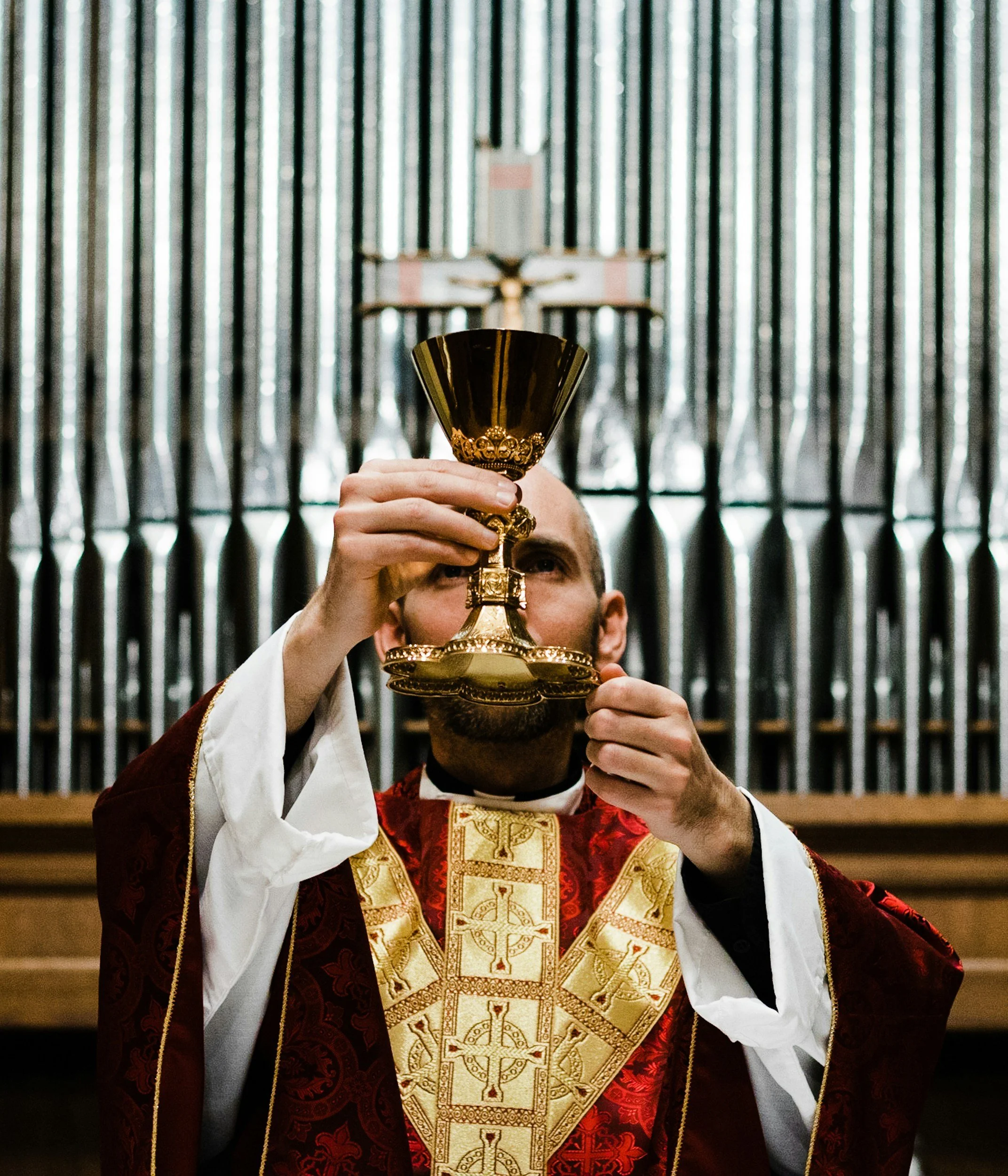 Priest holding a chalice during a Christian religious ceremony