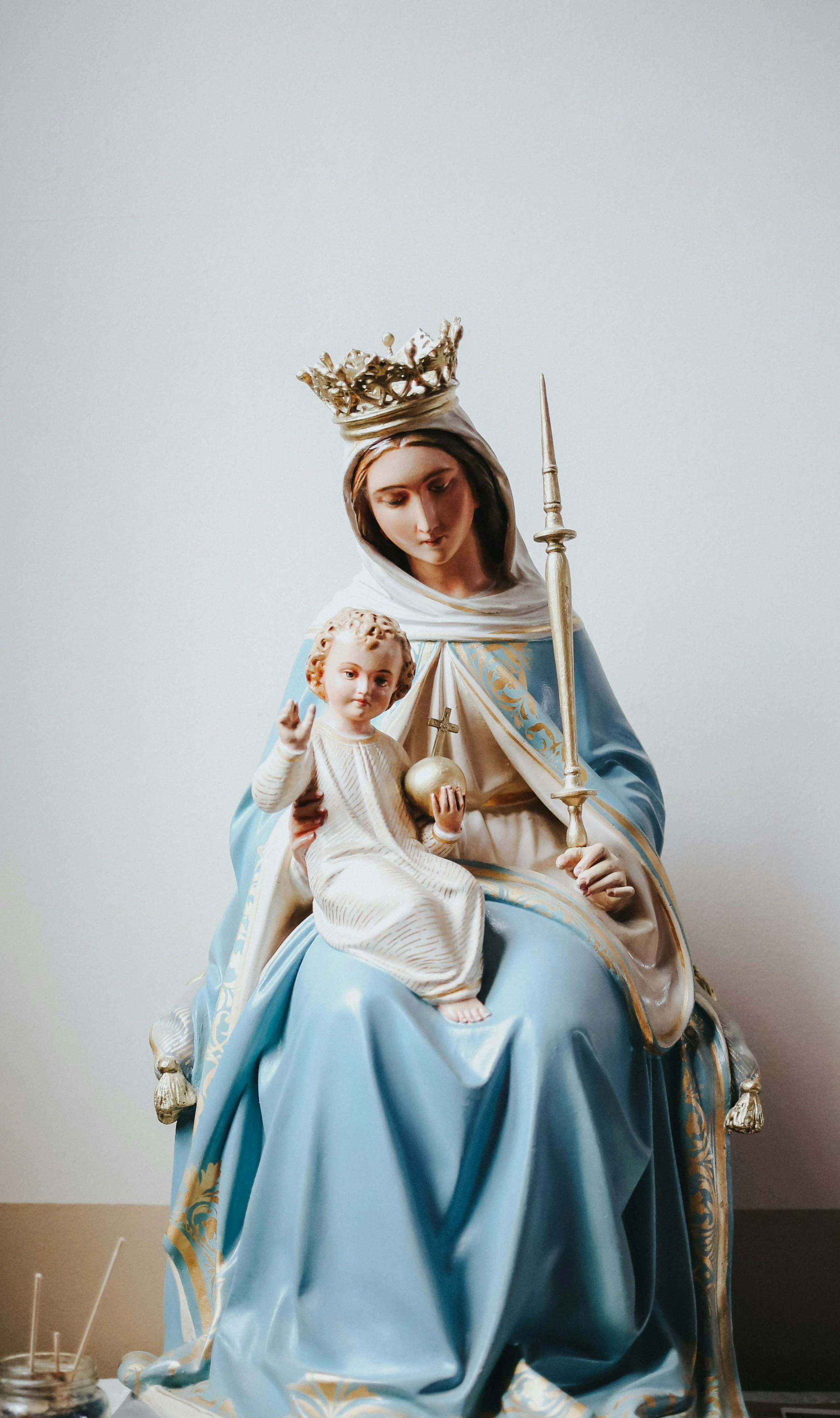 Religious statue of a crowned woman in blue holding a child, both with ornate details.