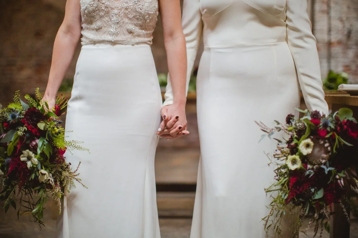 Same-sex couple in wedding dresses representing commitment and marriage