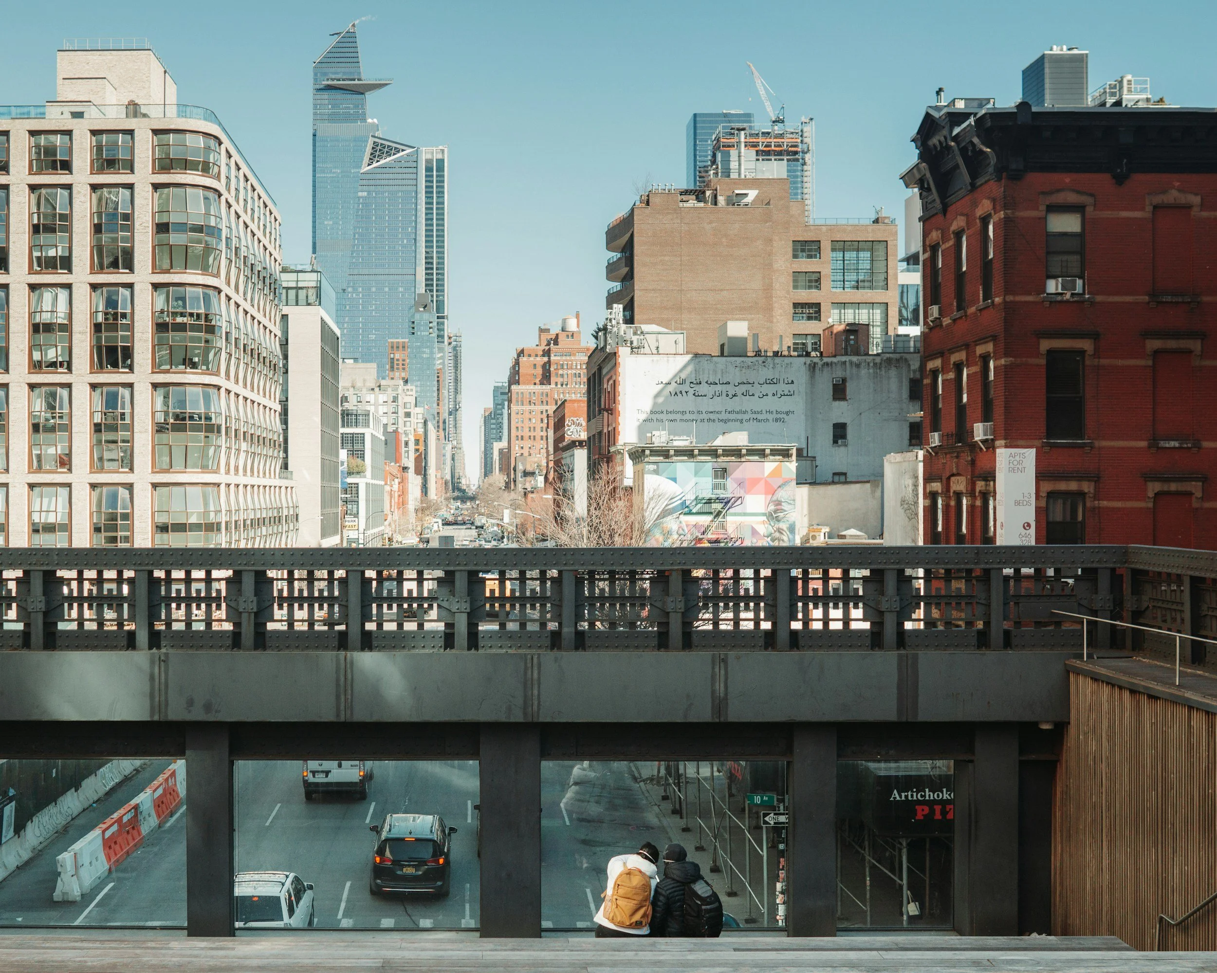 Couple sitting apart with Manhattan visible, representing challenges in relationships and the need for couples therapy