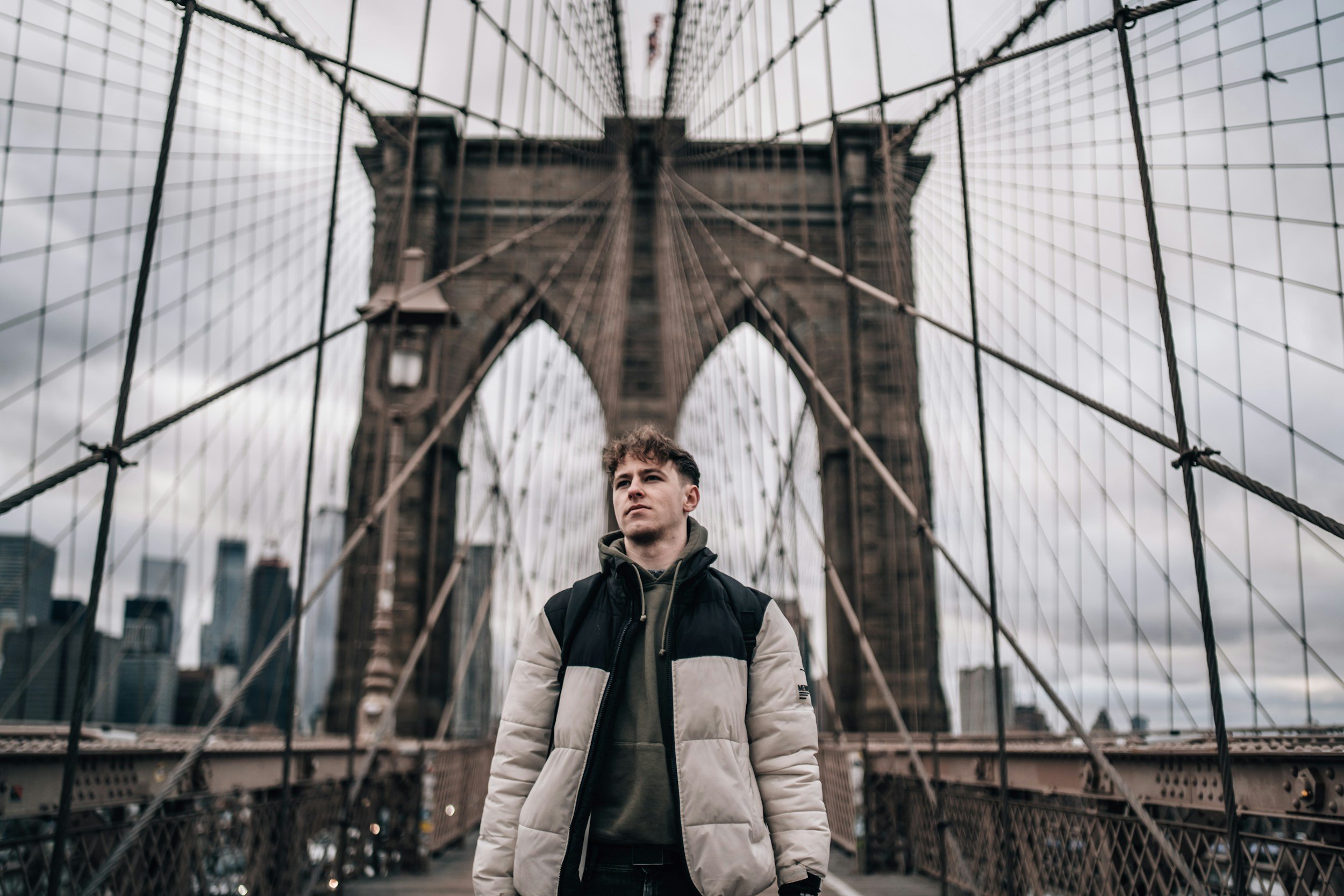 Teen standing on Brooklyn Bridge, representing ADHD and focus challenges