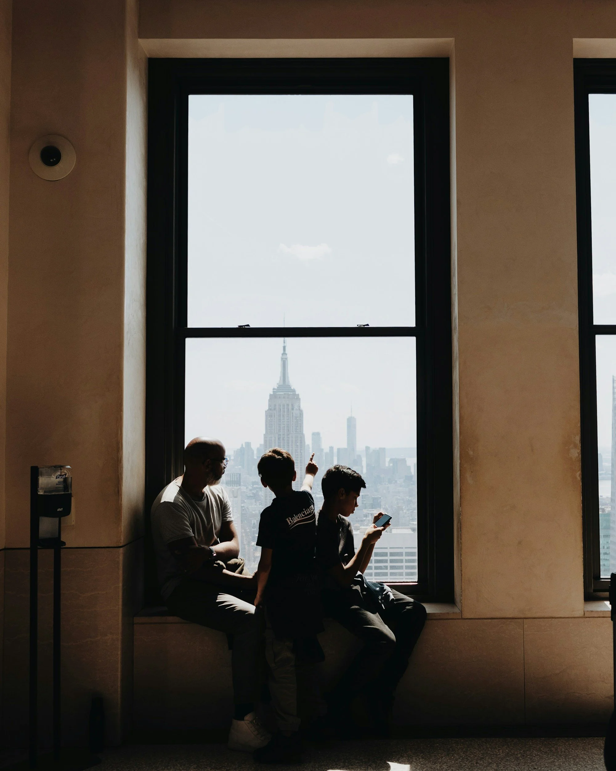 Parent and children looking at NYC skyline representing family therapy services