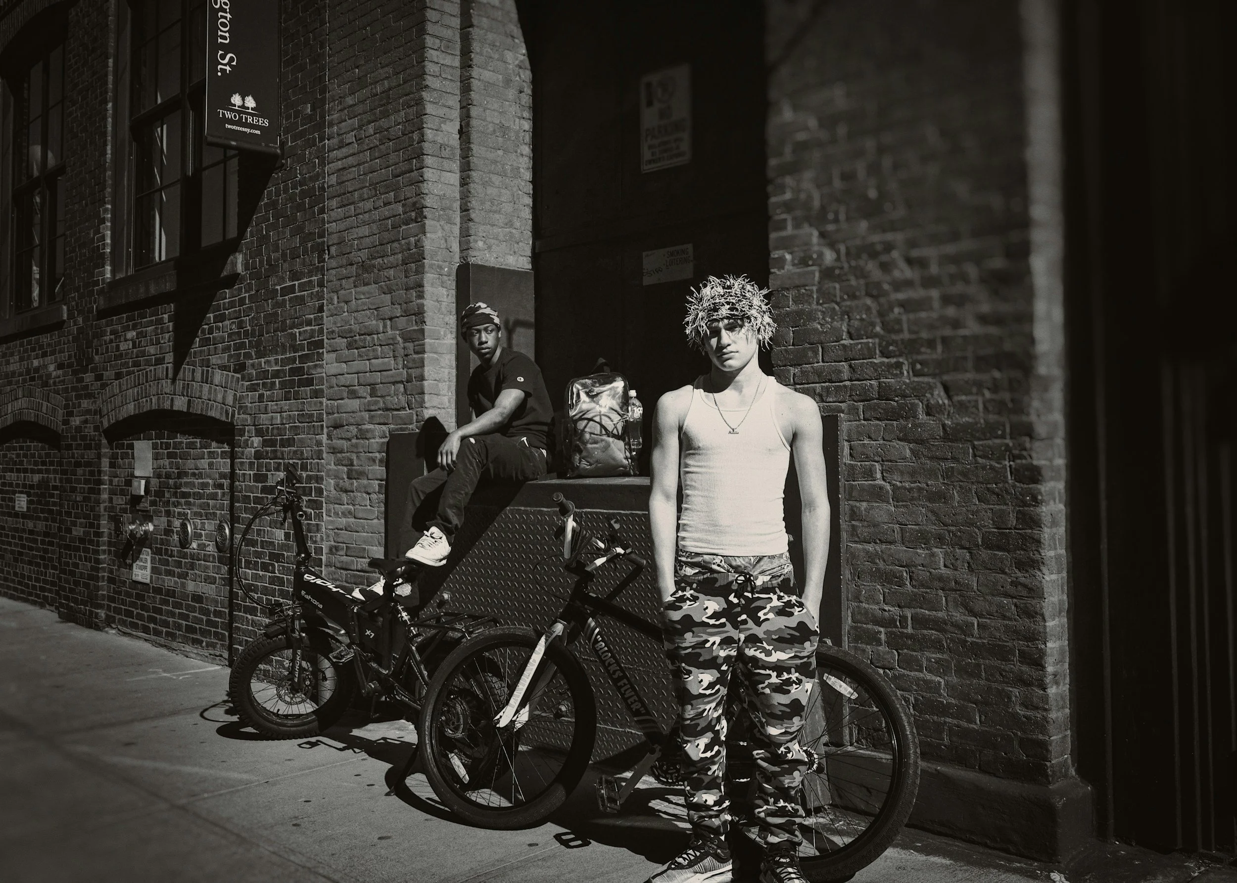 Teen standing in a city scene in black and white representing adolescence, emotional distance, and family change