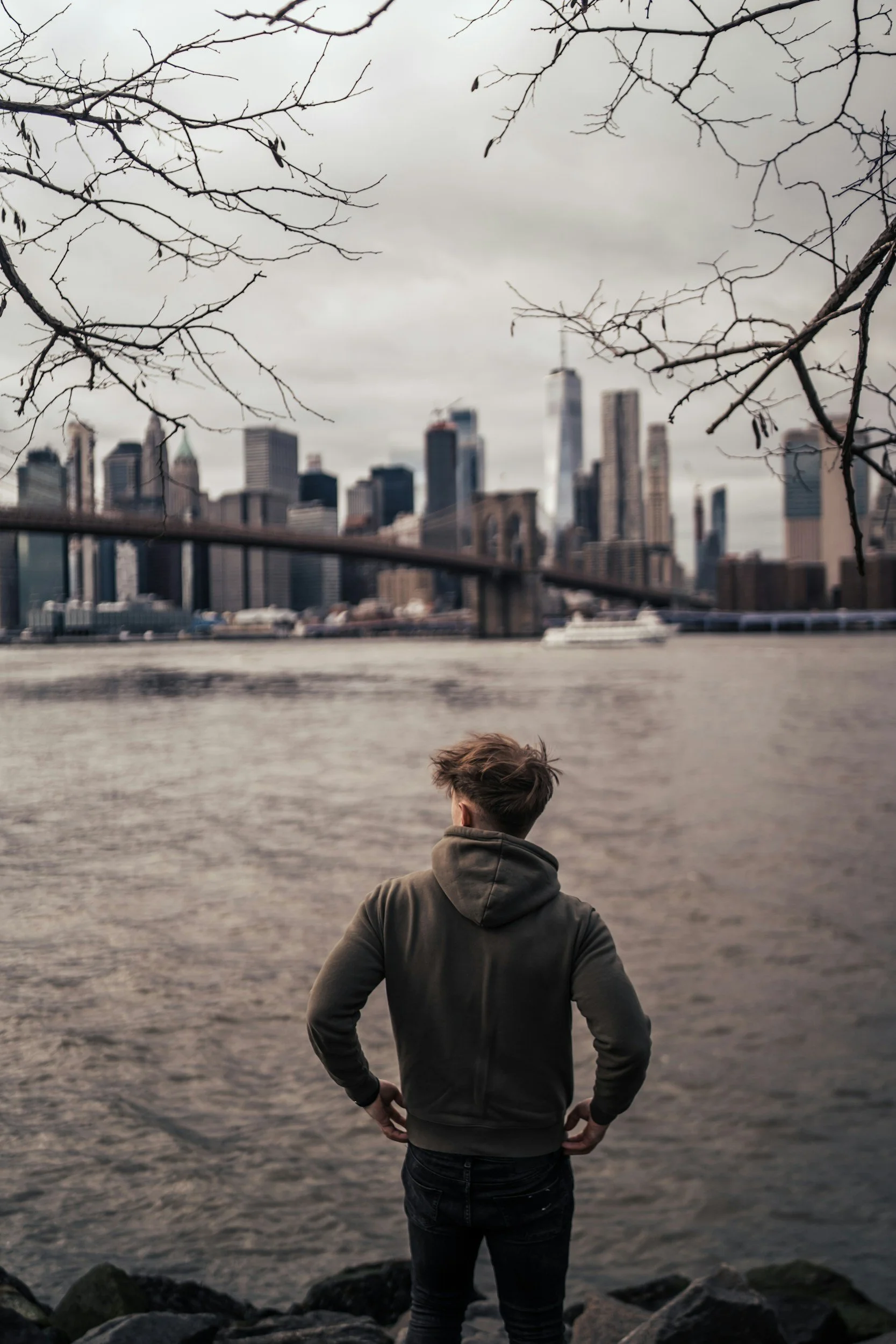Person reflecting while looking at the Brooklyn skyline, representing depression therapy and healing.