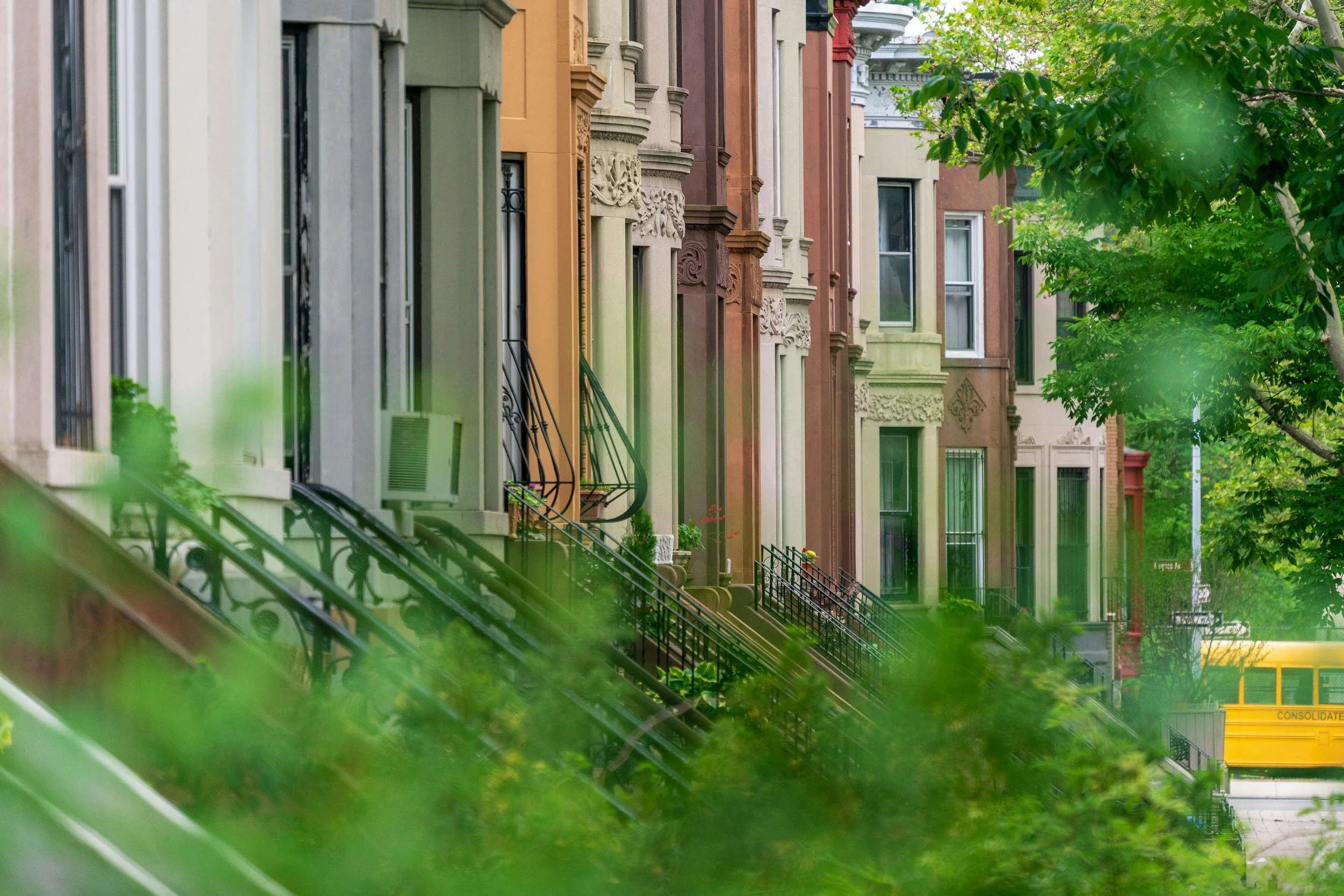 Tree-lined Brooklyn street with brownstone buildings near Groundwork Therapy.