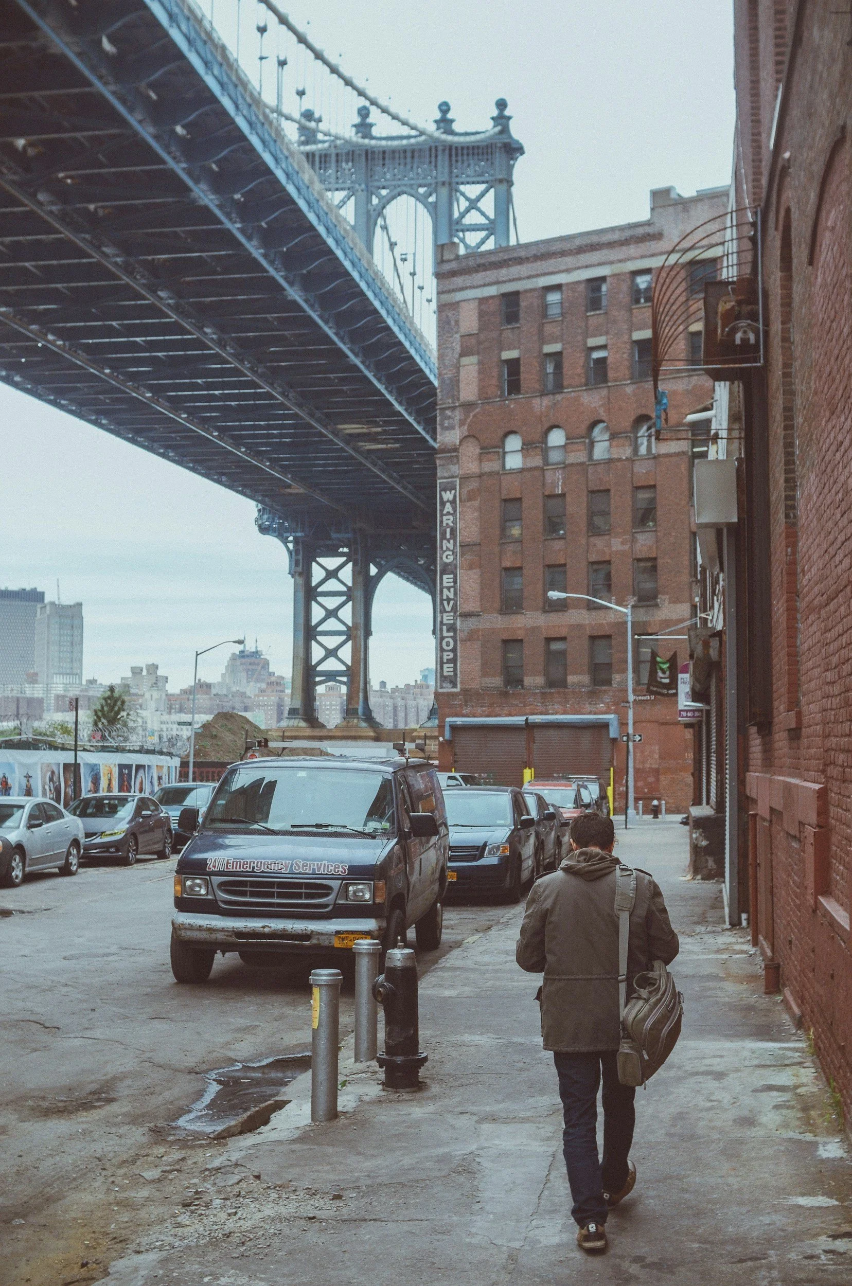 Person walking beneath a bridge in Brooklyn