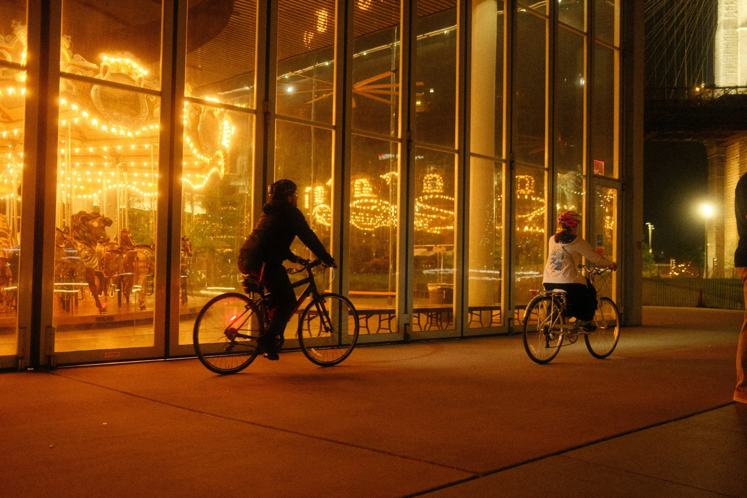 Two people riding a bike together on a Brooklyn street
