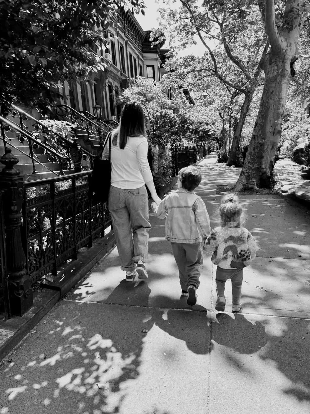 Mother walking through Brooklyn with two young children