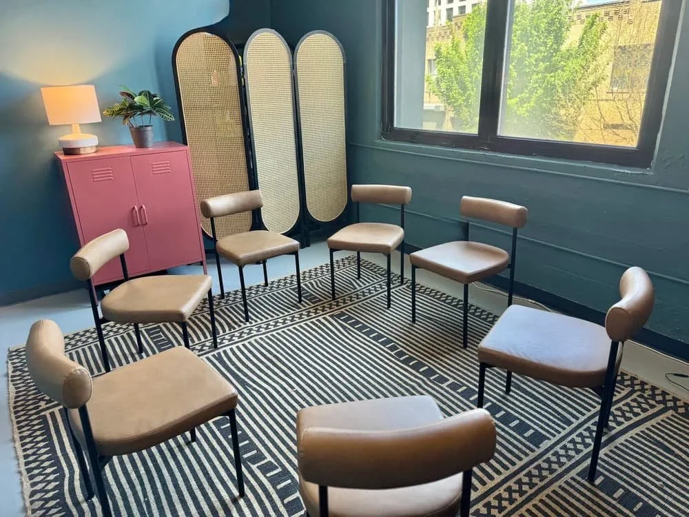 Circle of chairs in a therapy room for interpersonal process group sessions