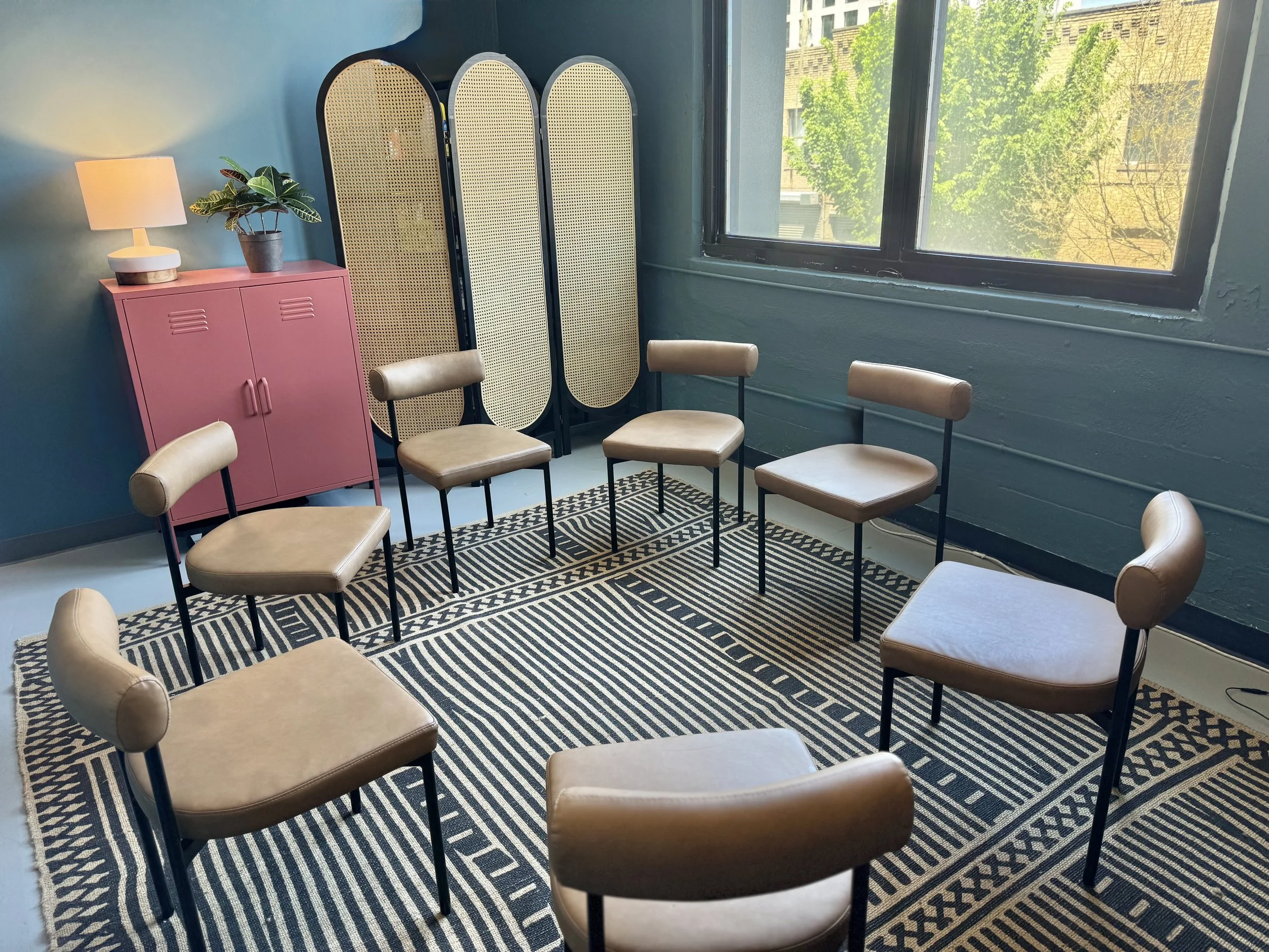 Circle of chairs in a therapy room for interpersonal process group sessions