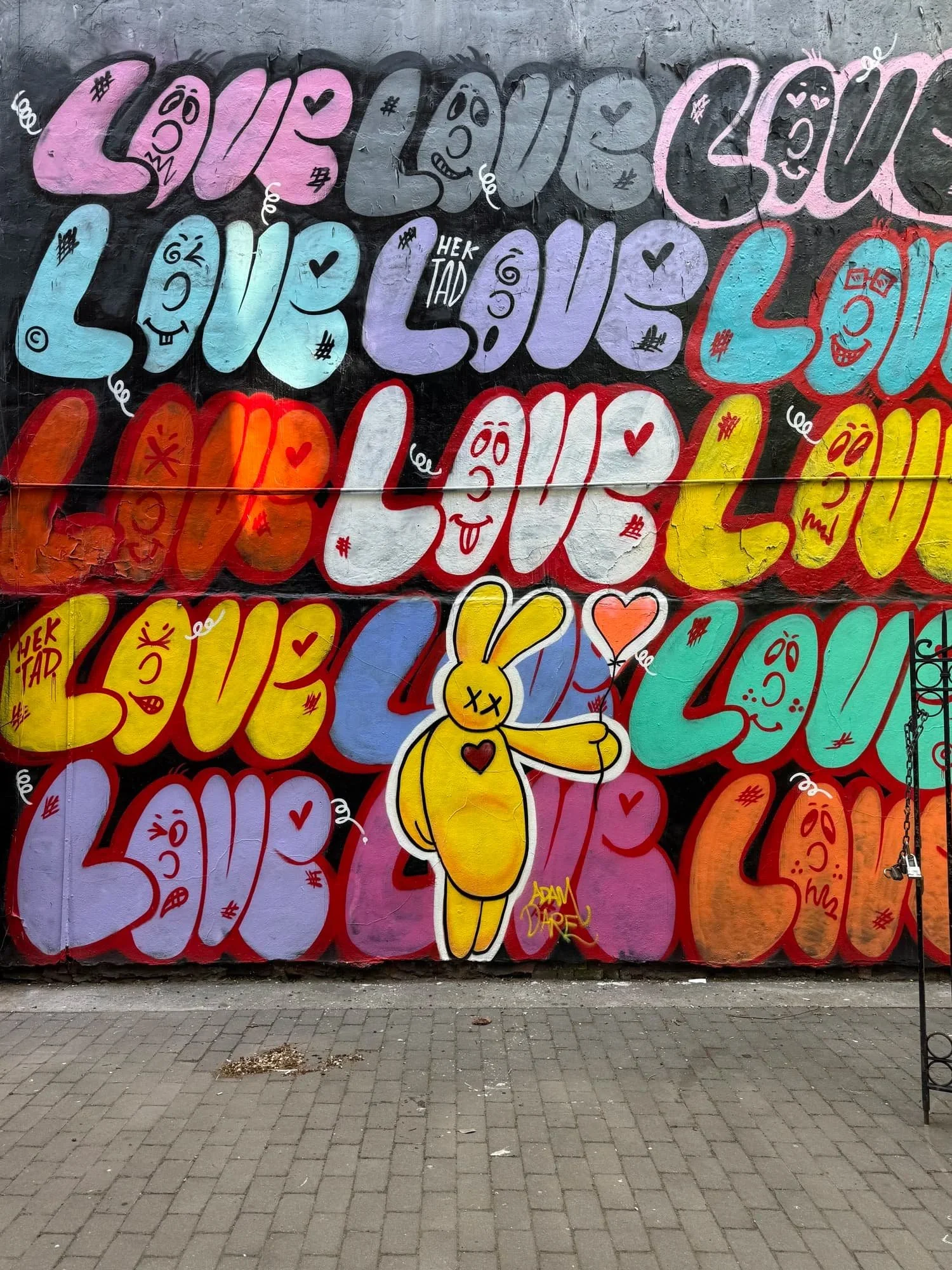 Mural displaying the word 'Love' repeatedly on a page about therapy for LGBTQ+ teens