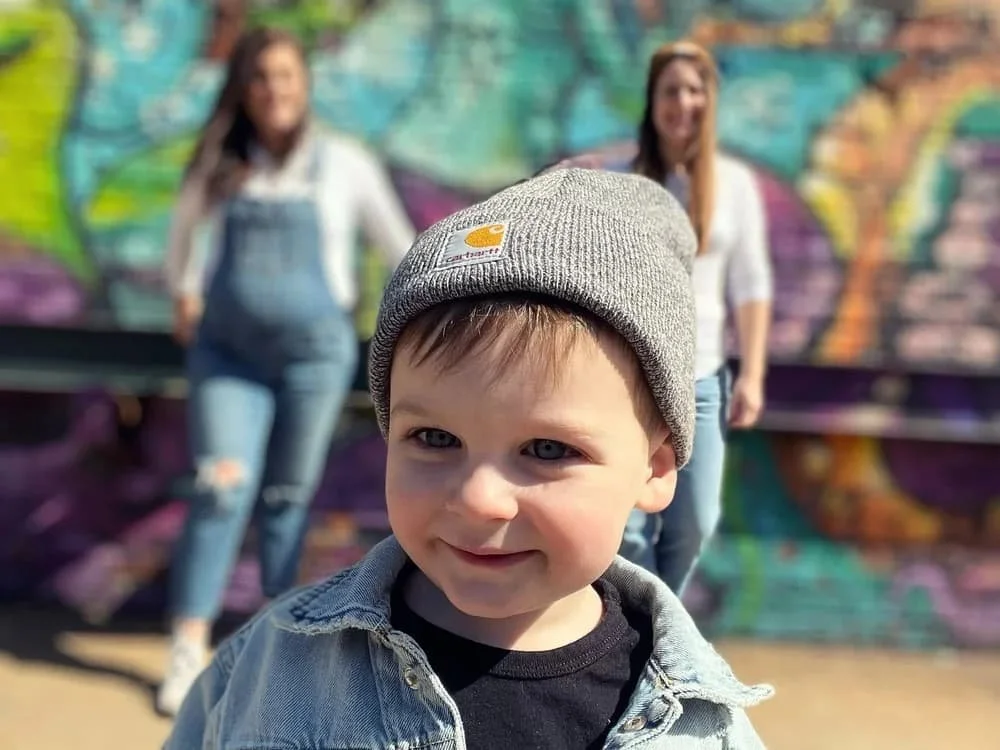 Two mothers with their child representing a queer family building therapy group
