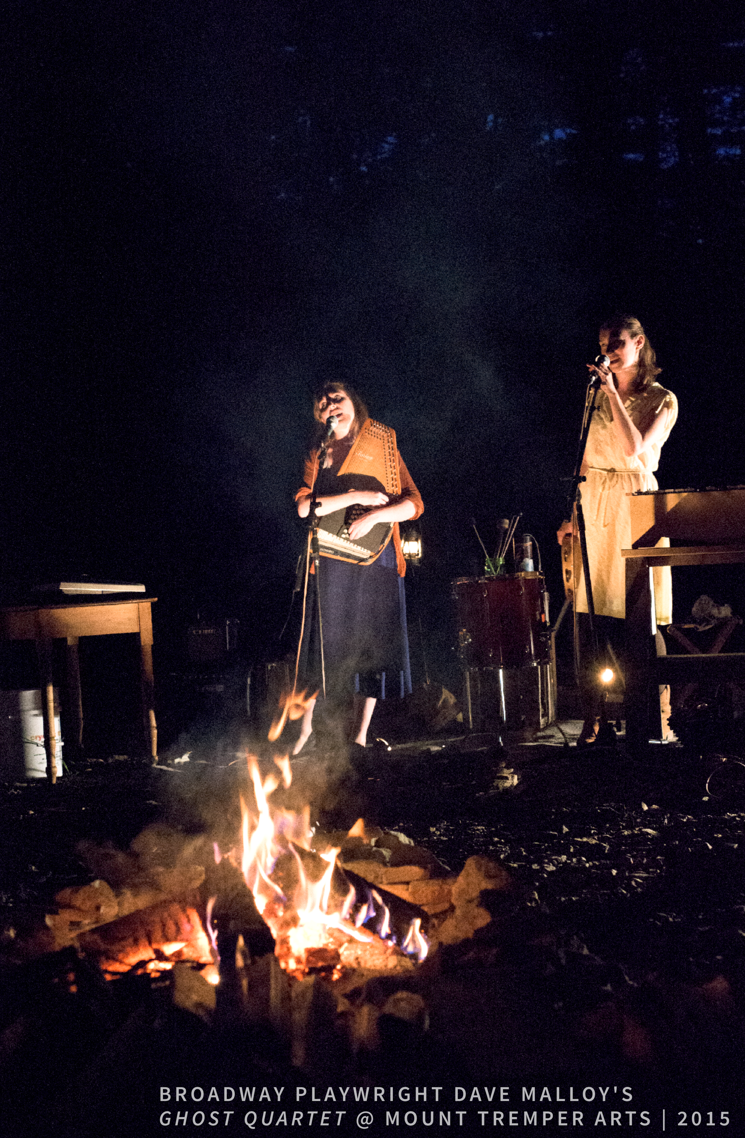 Broadway playwright Dave Malloy's Ghost Quartet at Mount Tremper Arts, 2015. Two singers, including Gelsey Bell, performing around a campfire at night.