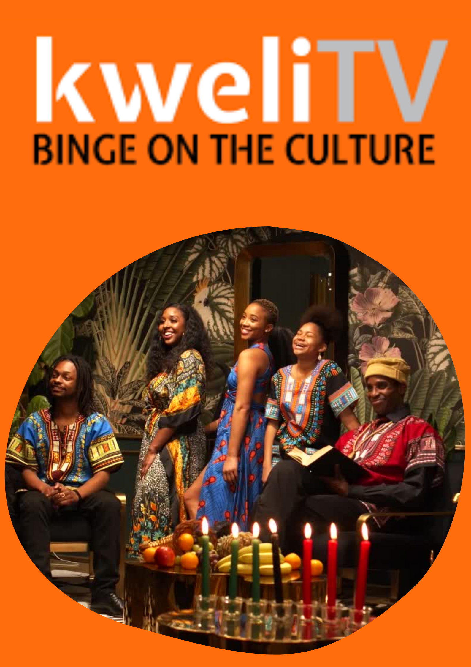 Cover of Kweli TV magazine with a group of five African-American people dressed in colorful traditional African attire sitting and standing around a table with lit candles and fruit, in a room with tropical wallpaper.