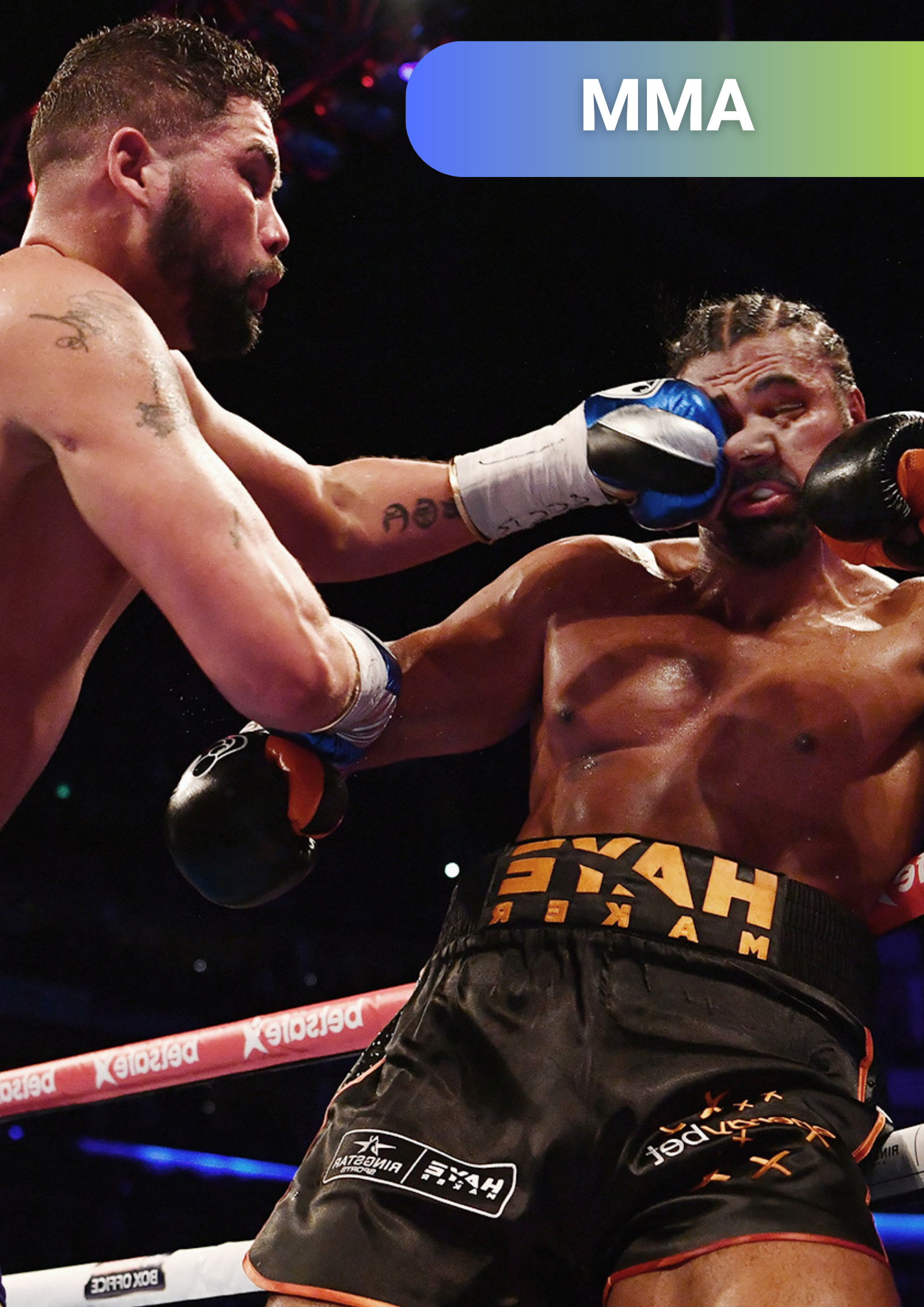 Two mixed martial arts fighters in a ring engaged in a fight, with one fighter landing a punch on the other's face.