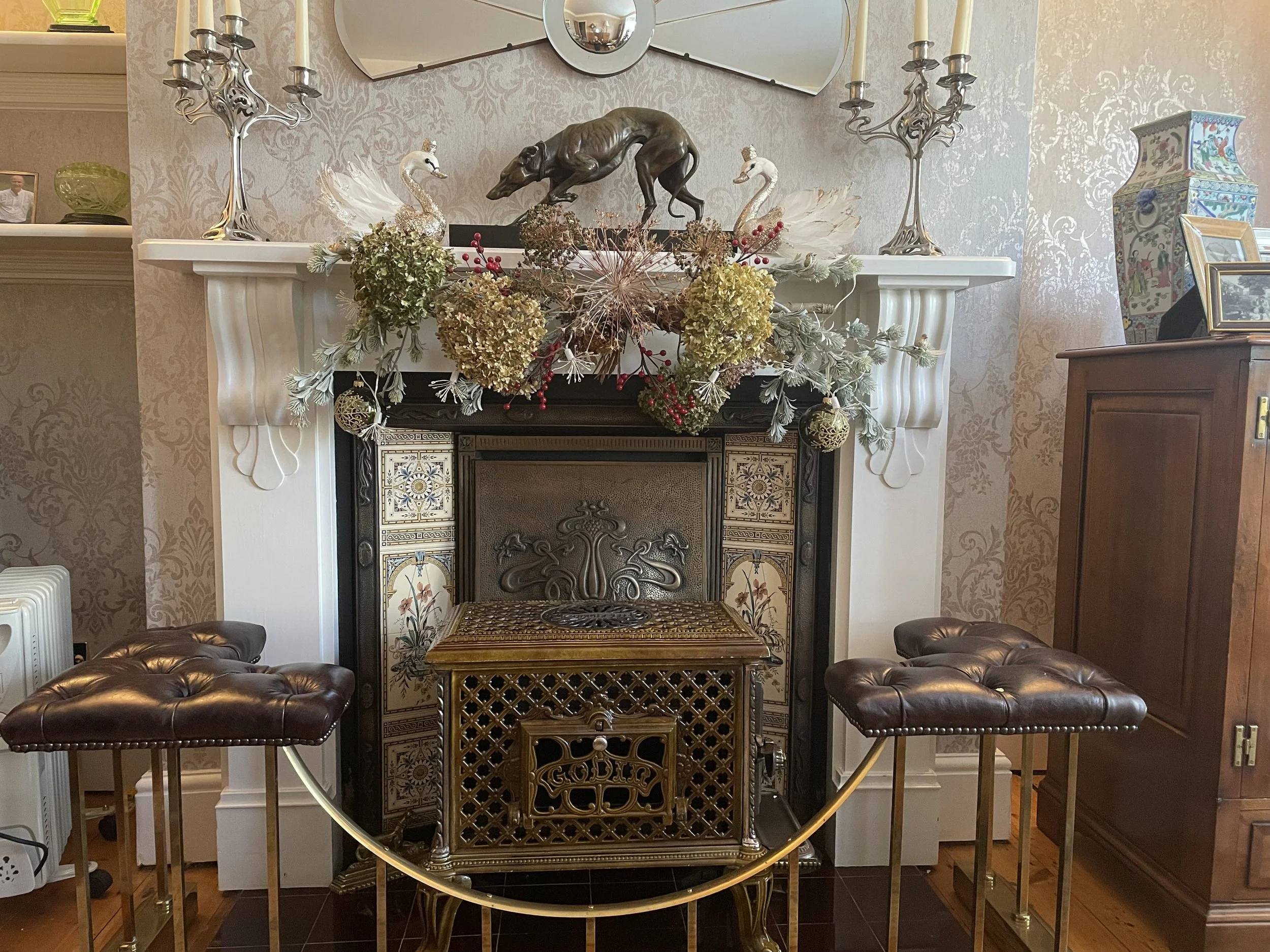 Godin Chauffette in ornate fireplace with art nouveau candlesticks