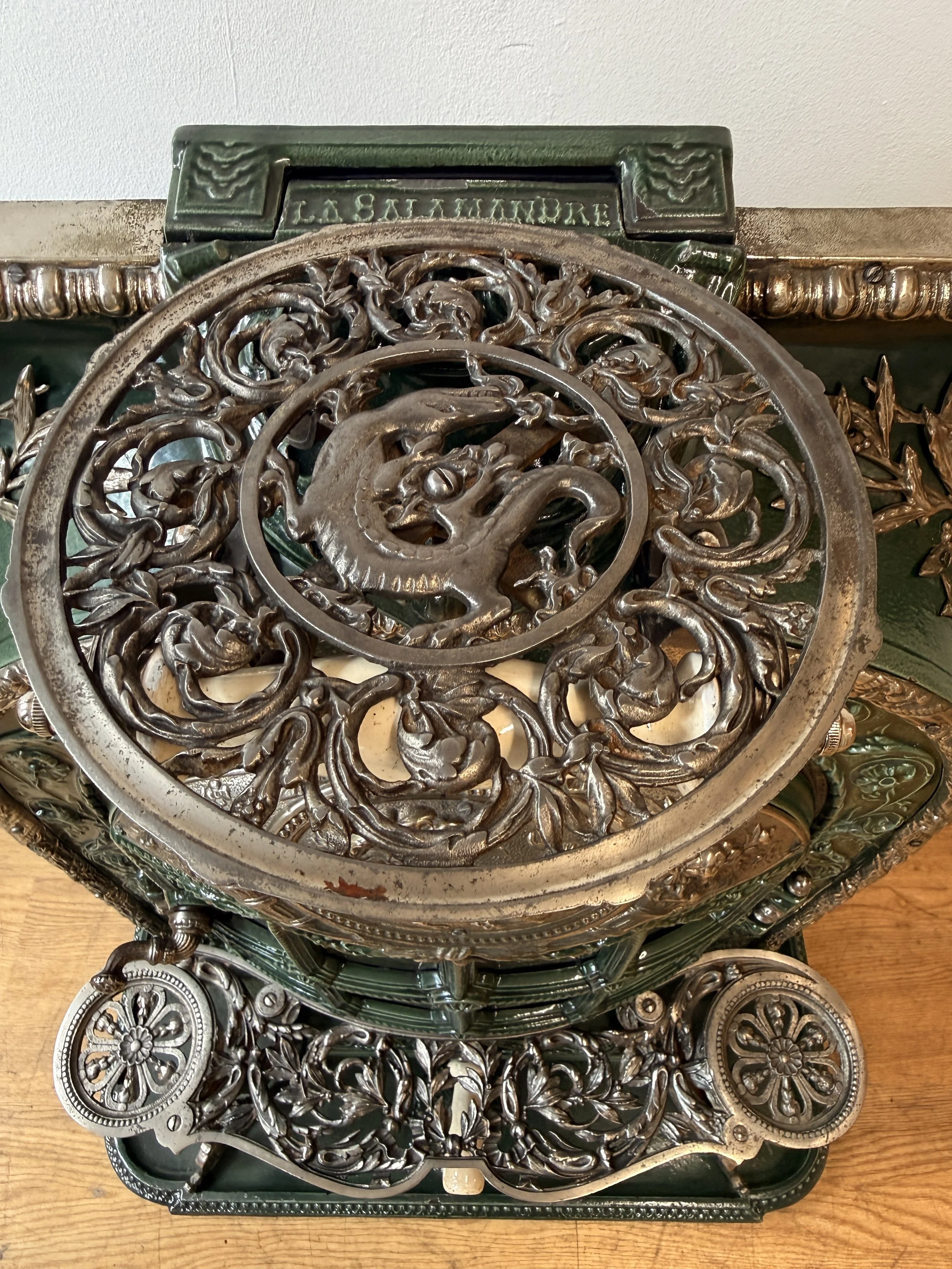 Detail of a round trivet on the handle of an antique stove