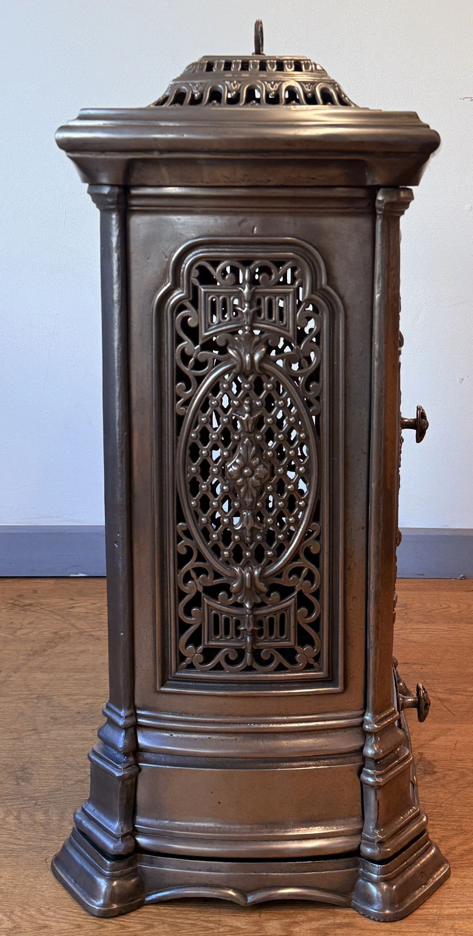 Side view showing detail of a cast iron French stove