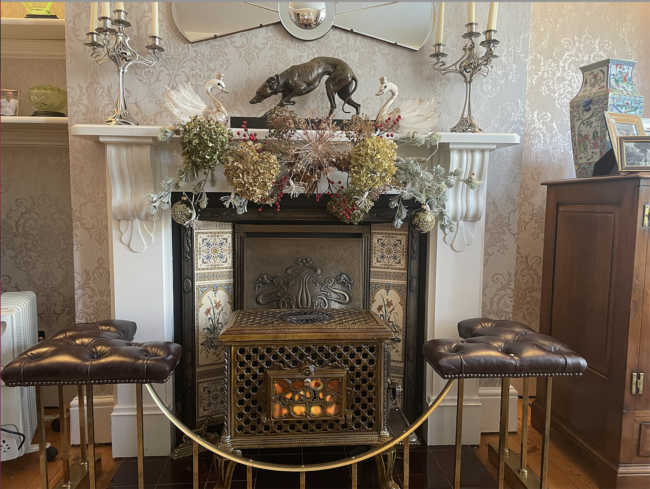 Godin Chauffette in ornate fireplace with art nouveau candlesticks