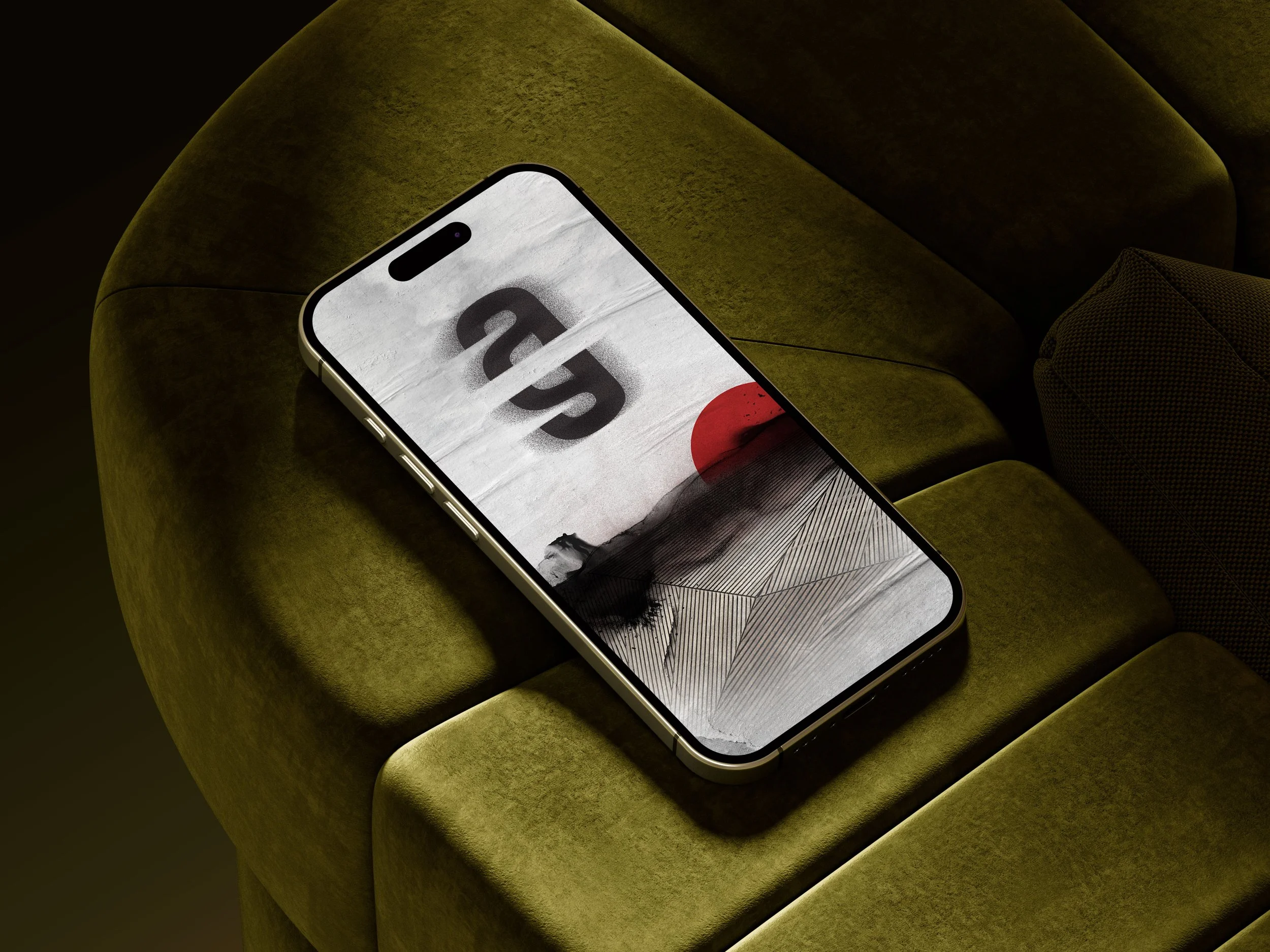A modern smartphone with a cracked screen resting on a green velvet armchair.