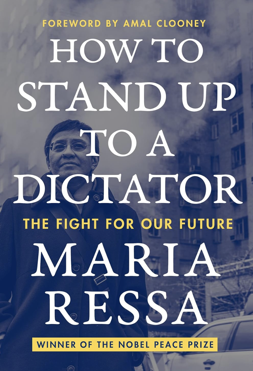 Book cover of 'How to Stand Up to a Dictator' by Maria Ressa, with a background photo of a woman with short hair and glasses, against a cityscape with buildings and trees.