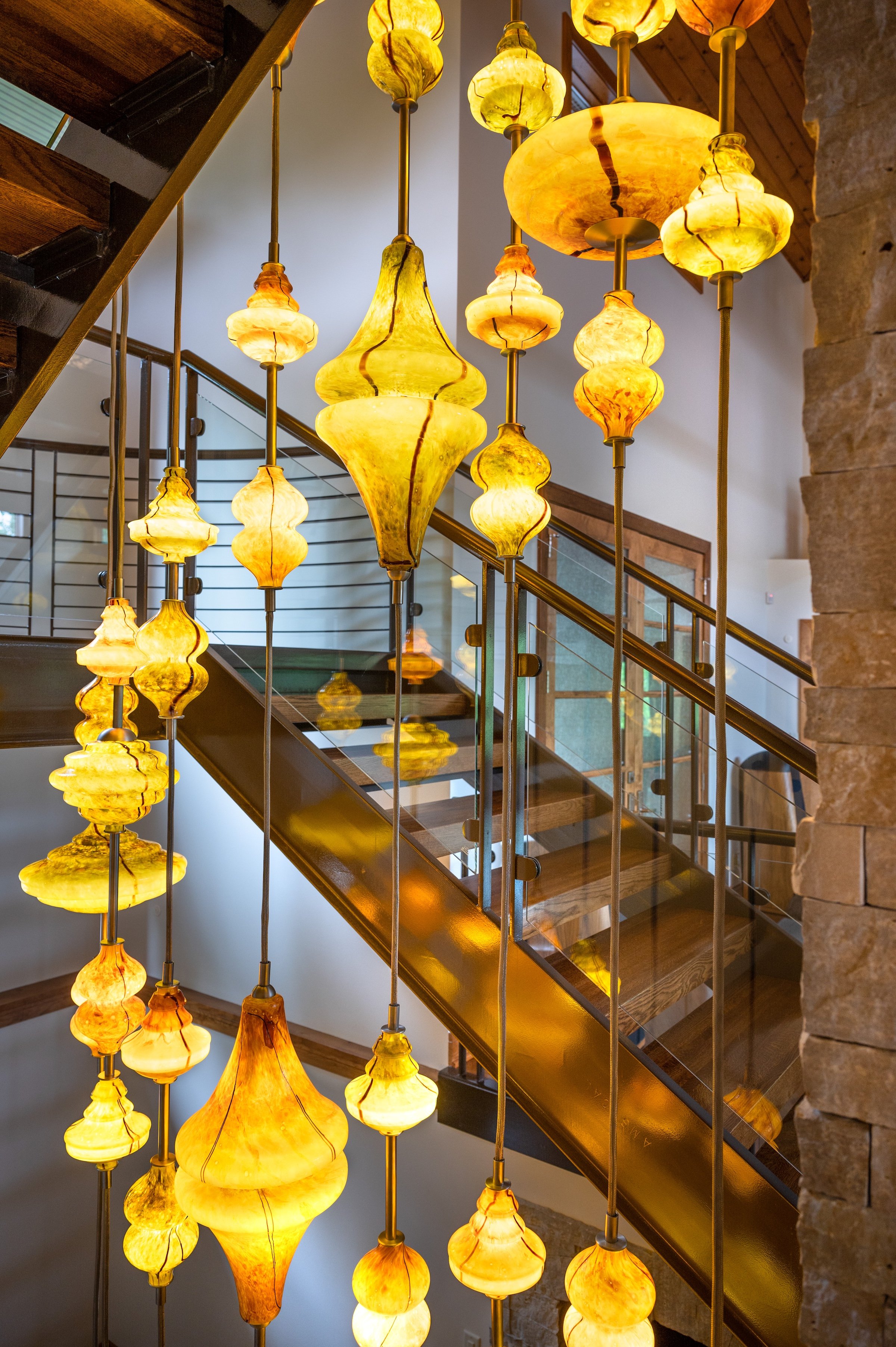 amber glass pendant installation in stairwell