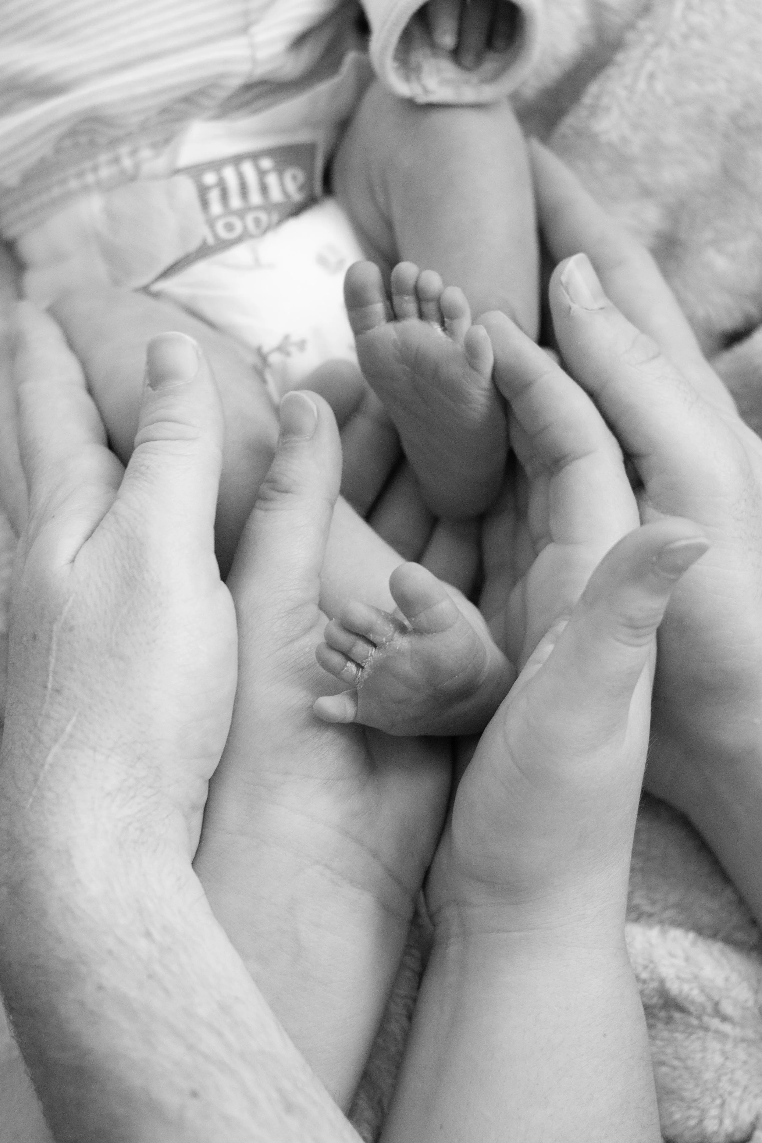 Baby feet parents hands