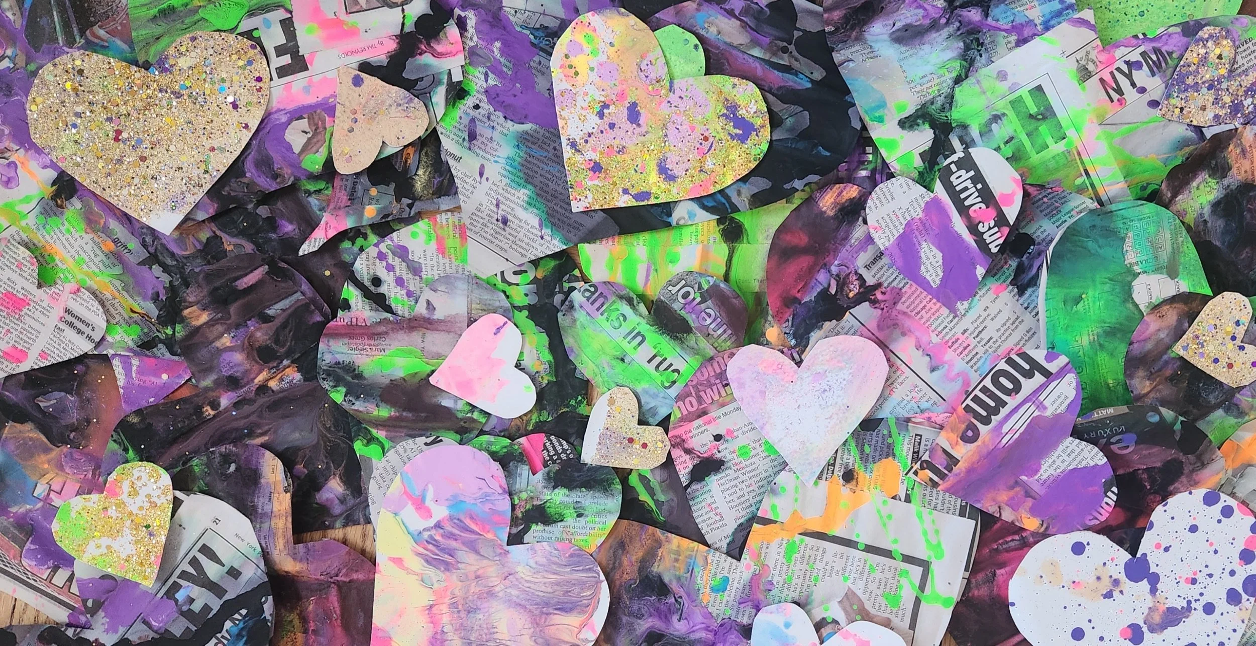 Kids participating in a Halloween arts and crafts activity at a table with colored paper, chalk, and decorations in a classroom or activity room.