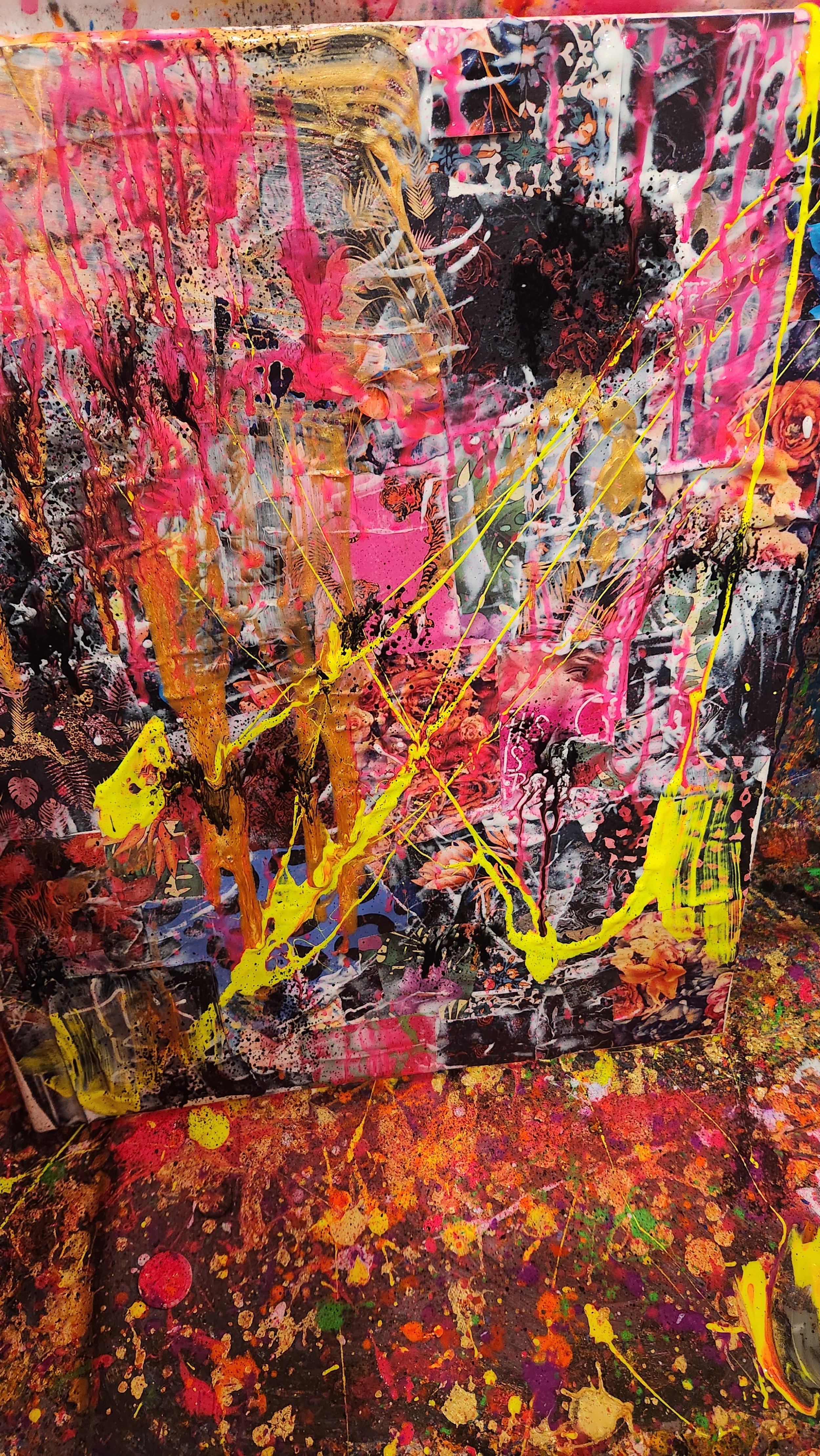 Abstract expressionist painting with splashes and streaks of bright pink, yellow, black, and orange paint, layered over a collage of newspaper clippings and images.