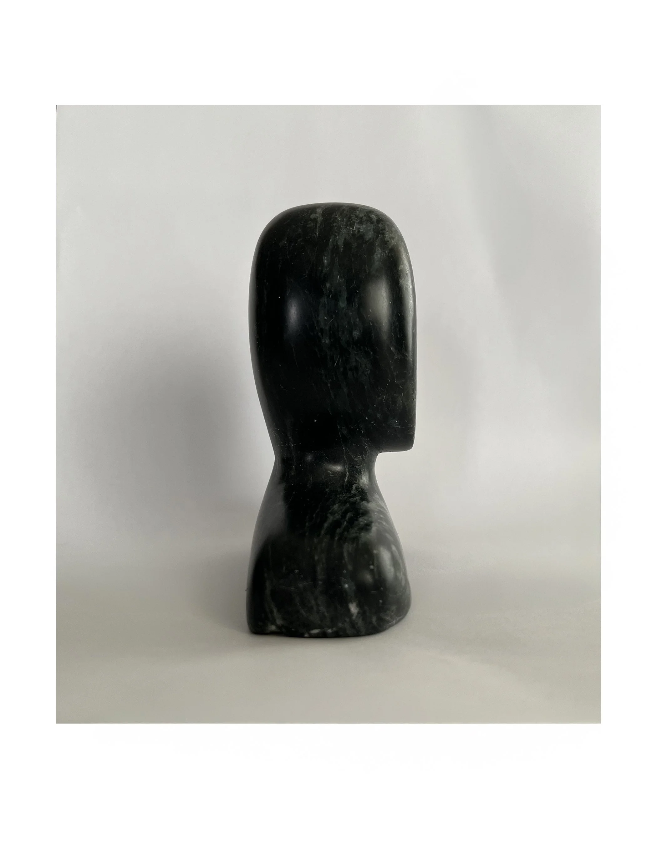 Abstract black marble sculpture of a human head