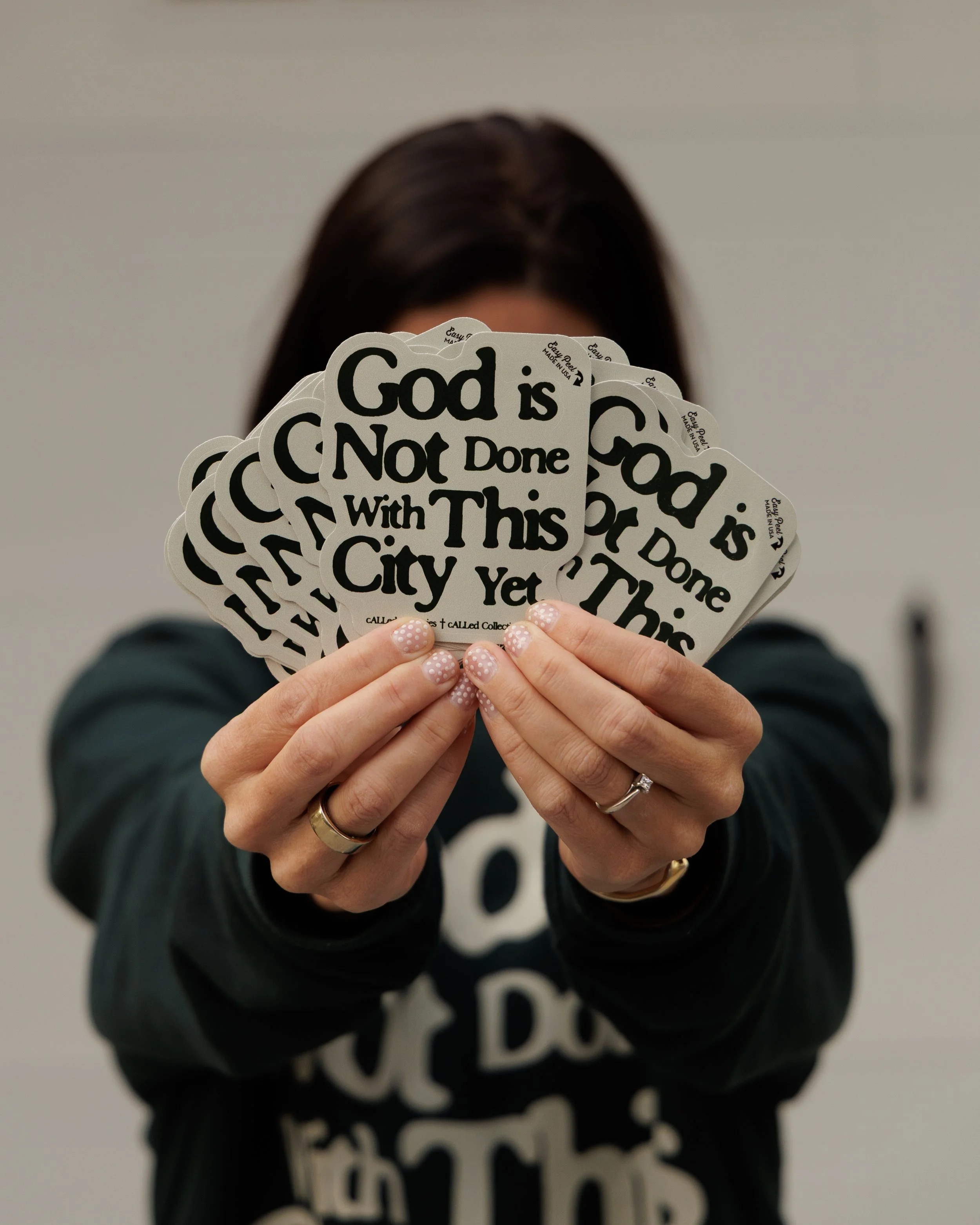 "God is not done with this city yet" sticker