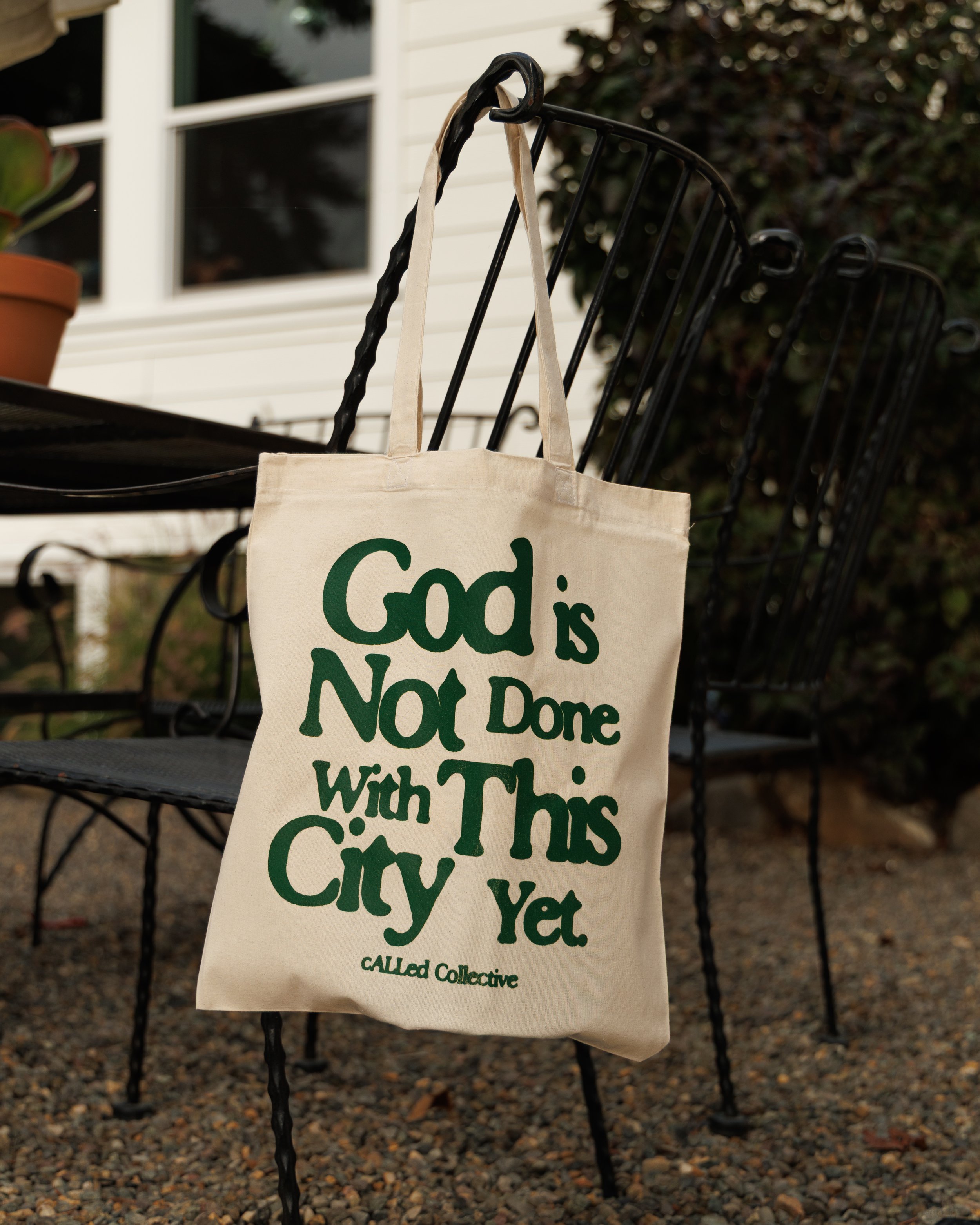 "God is not done with this city yet" tote bag